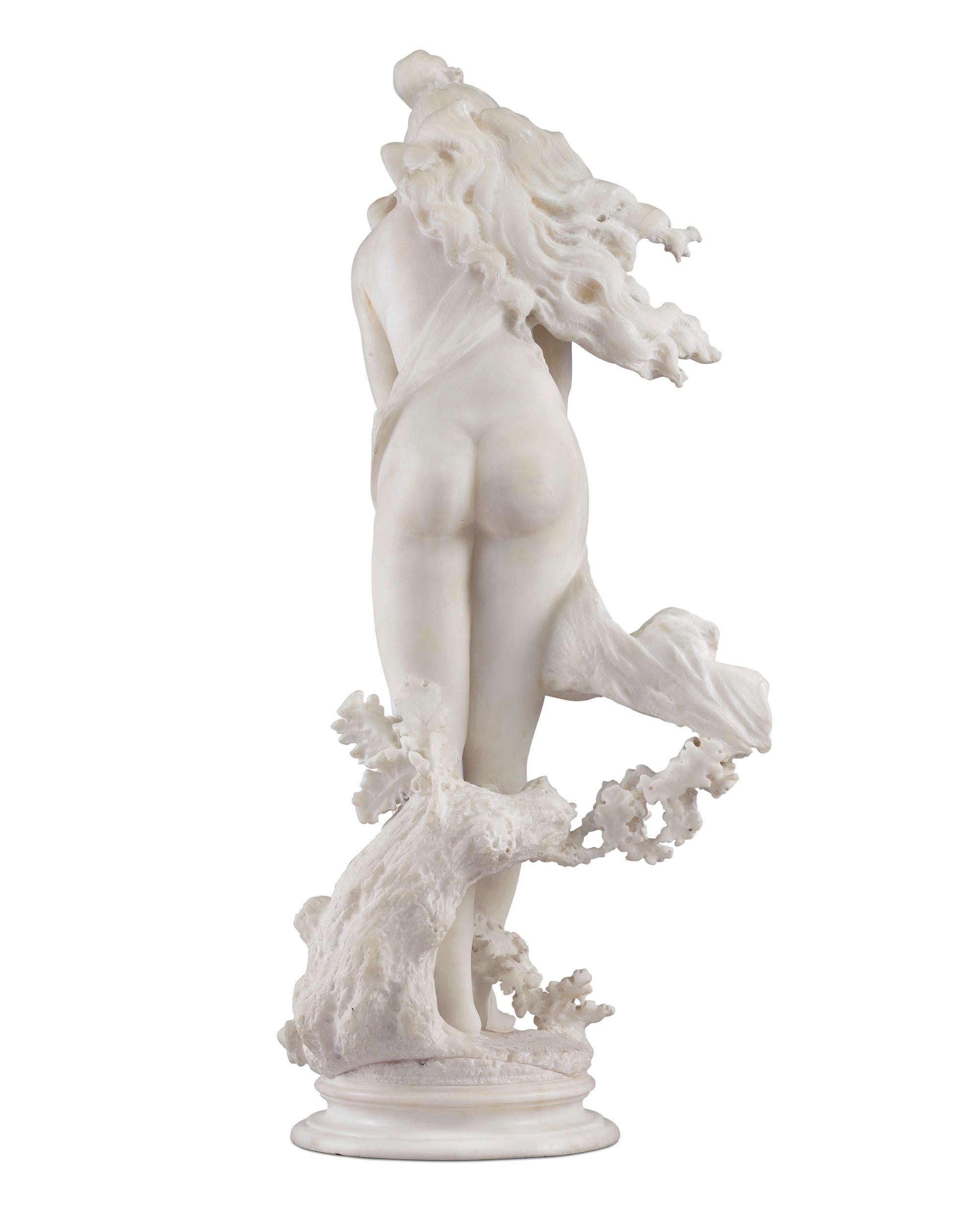 A beautiful woodland nymph playfully covers her nude form in this white marble sculpture by the Florentine artist Vittorio Caradossi. The nymph emerges from the forest decorated in beads and windblown, an effect effortlessly achieved by Caradossi,