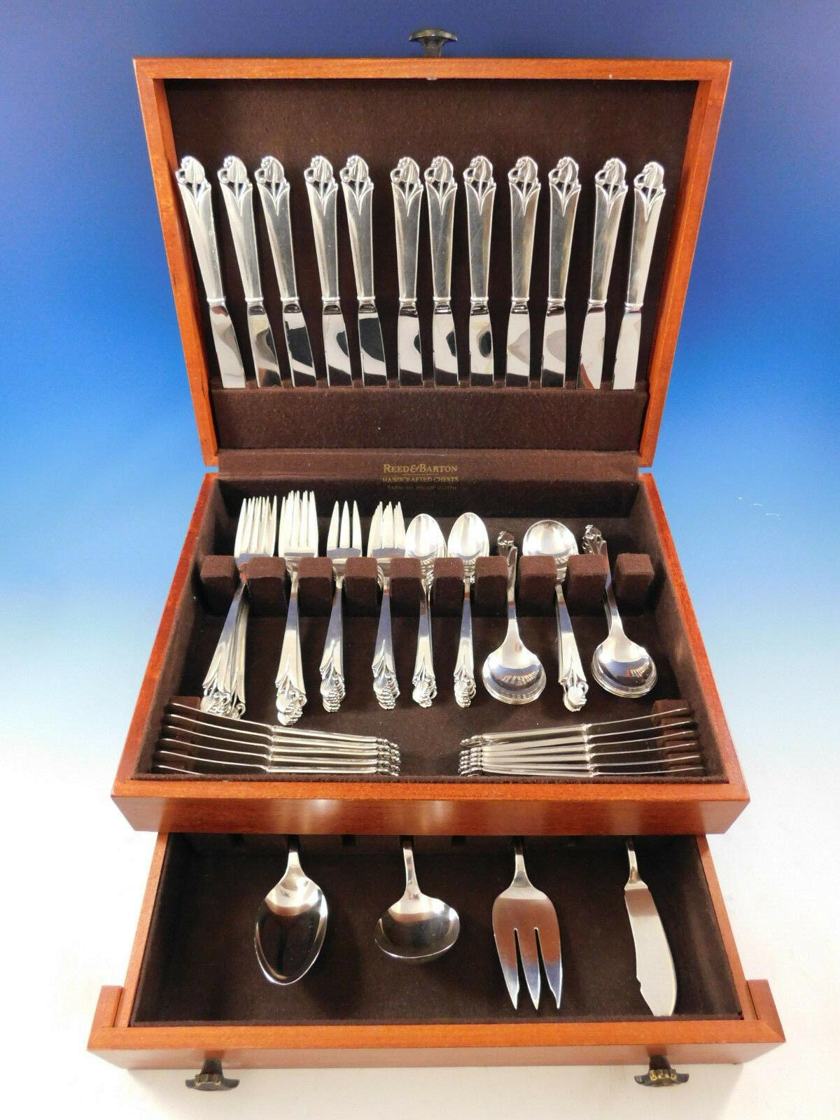 Woodlily by Frank Smith (Glossy finish) sterling silver flatware set. This graceful pattern features a 'Danish-moderne style' with stylized leaf. This 77 piece set includes:

12 knives, 8 3/4