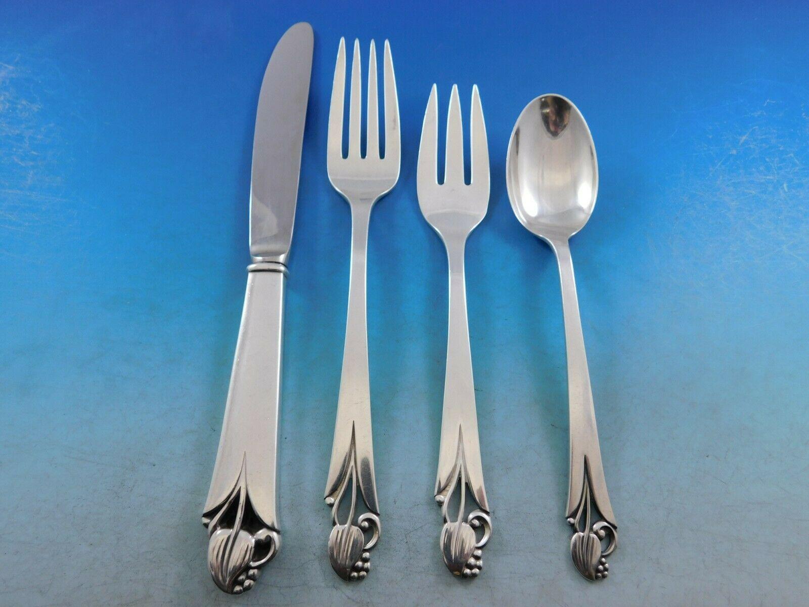 Woodlily (Glossy finish) by Frank Smith sterling silver flatware set, 53 pieces. This graceful pattern features a stylized leaf and openwork at the top of the handle around the stem, and bead detailing. This set includes:


8 knives, 8 7/8