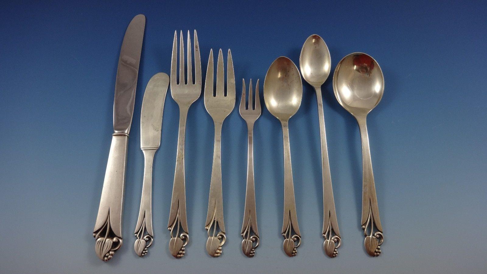 Woodlily by Frank Smith (Glossy finish) sterling silver flatware set of 69 pieces. This graceful pattern features a 