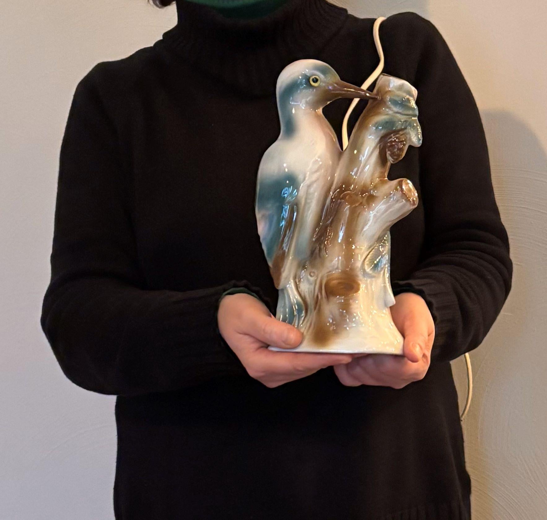 Woodpecker perfume light. 
A beautiful porcelain perfume light or perfume lamp 
in the shape of a woodpecker bird. 
A bird table lamp from the Art Deco period circa 1930 - 1940.
Porcelain animal statue - animal sculpture in beautiful colors.
Old