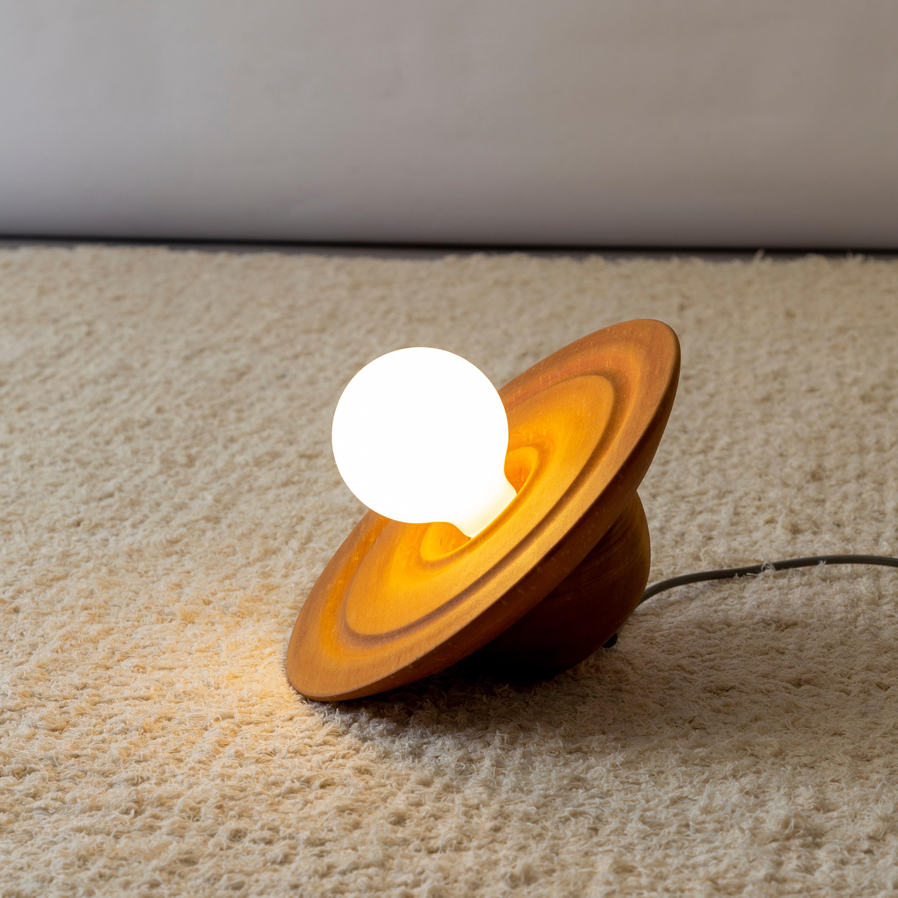 The Astro Rei table lamp is a design piece made entirely of noble wood and handcrafted in the turning process. Each piece is carefully molded by hand, resulting in a lamp with a high-quality finish and a natural, organic charm.

One of the most