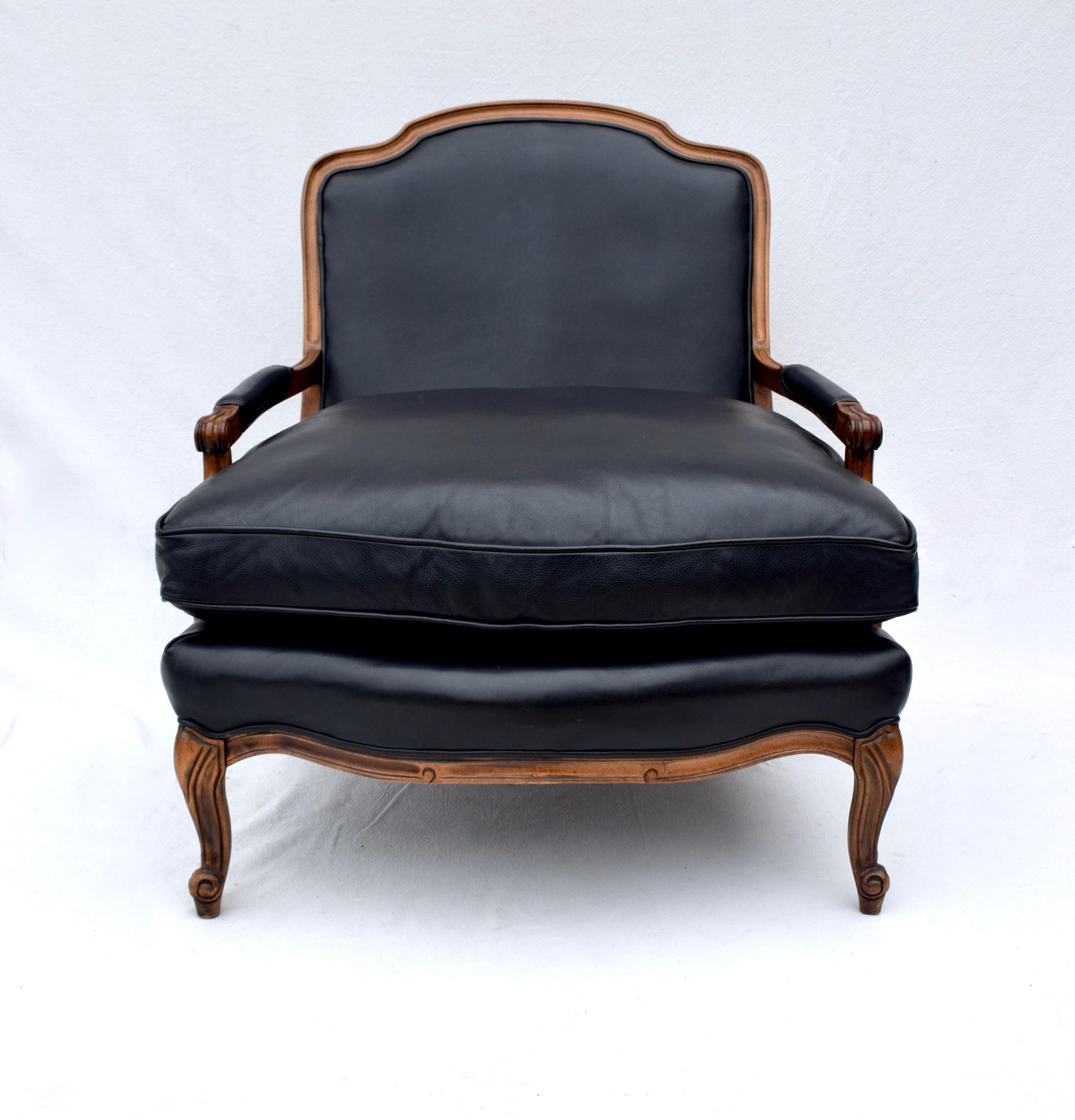 20th Century Woodward & Lothrop Top of the Line Black Leather and Walnut Club Chair & Ottoman