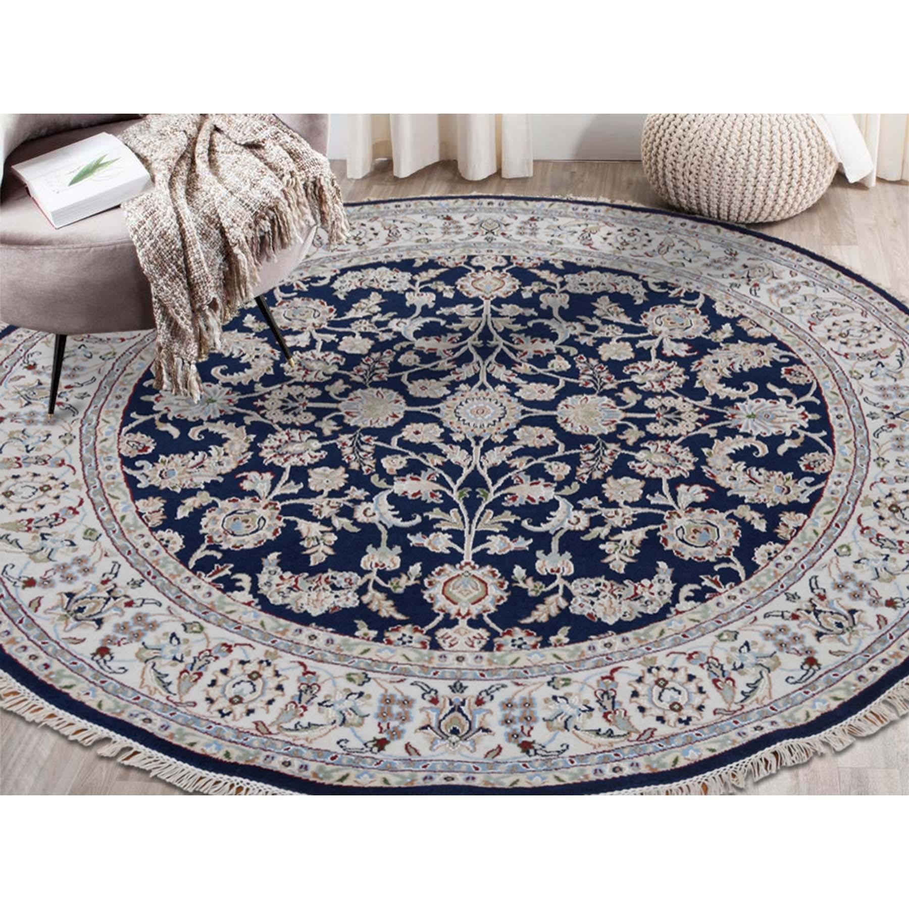 This is a truly genuine one-of-a-kind wool and silk 250 KPSI navy Nain hand knotted oriental round rug. It has been knotted for months and months in the centuries-old Persian weaving craftsmanship techniques by expert artisans. Measures: 5'10