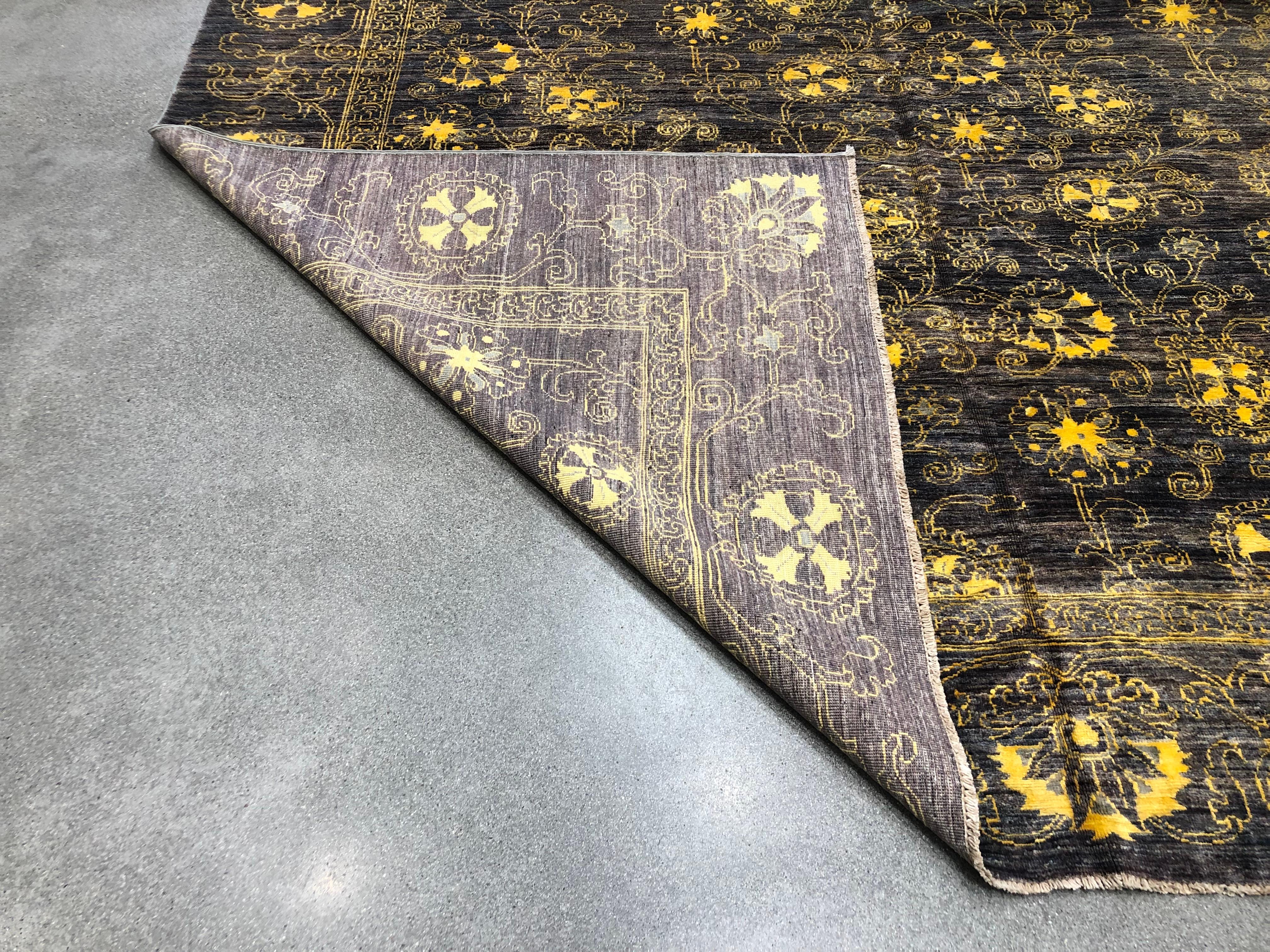 The colors of gold and eggplant with a combination of wool and silk materials make this rug a luscious and rich option for your space. This all over design rug with a border is handmade and hand knotted from Pakistan.