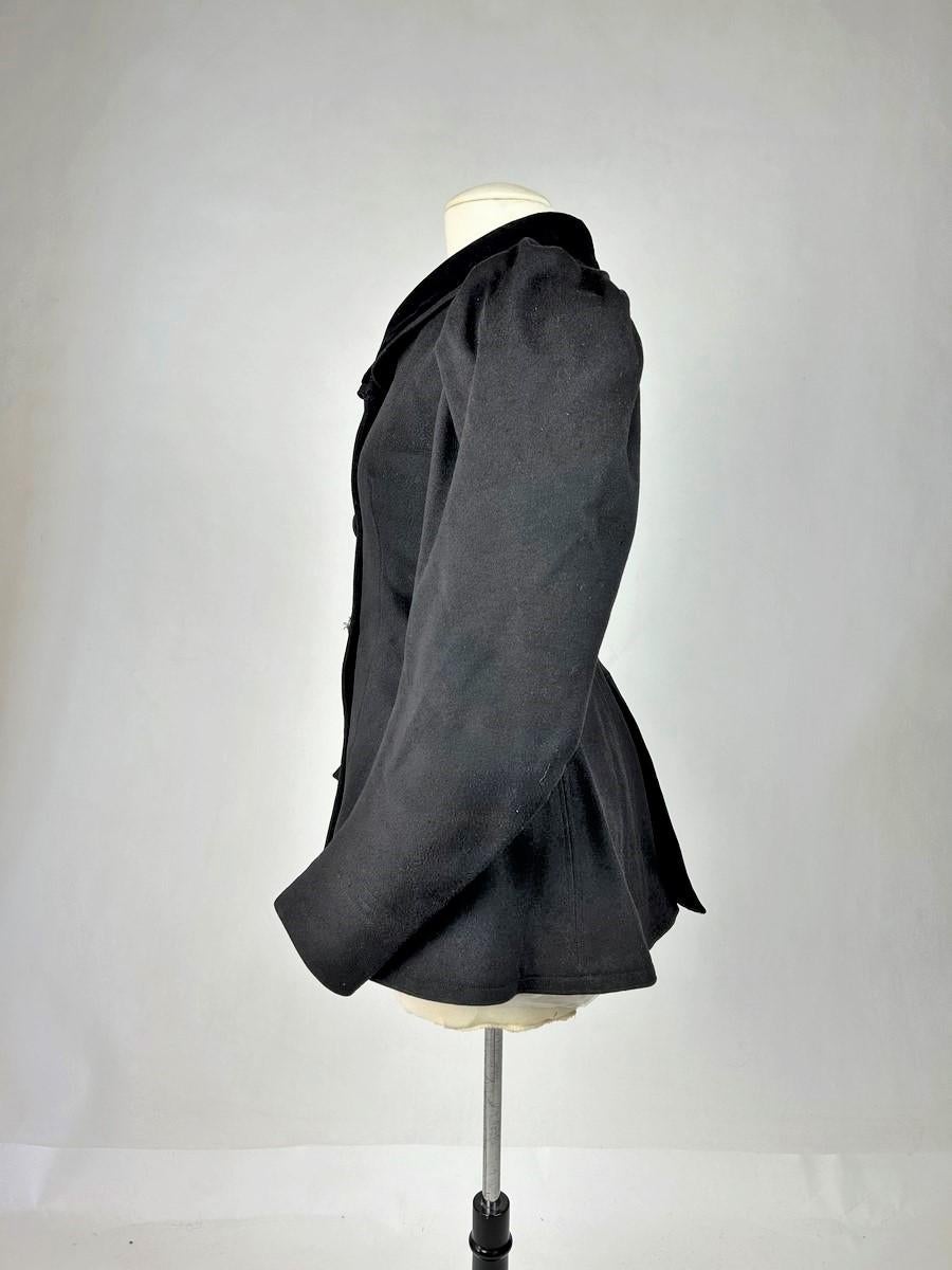 Circa 1895-1905
France

Amazon jacket in black felted woollen cloth and silk velvet shawl collar dating from the French Belle Epoque. Fitted jacket with long basques, slit at the back, angled sleeves with Gigot pleats at the shoulders. Fully lined