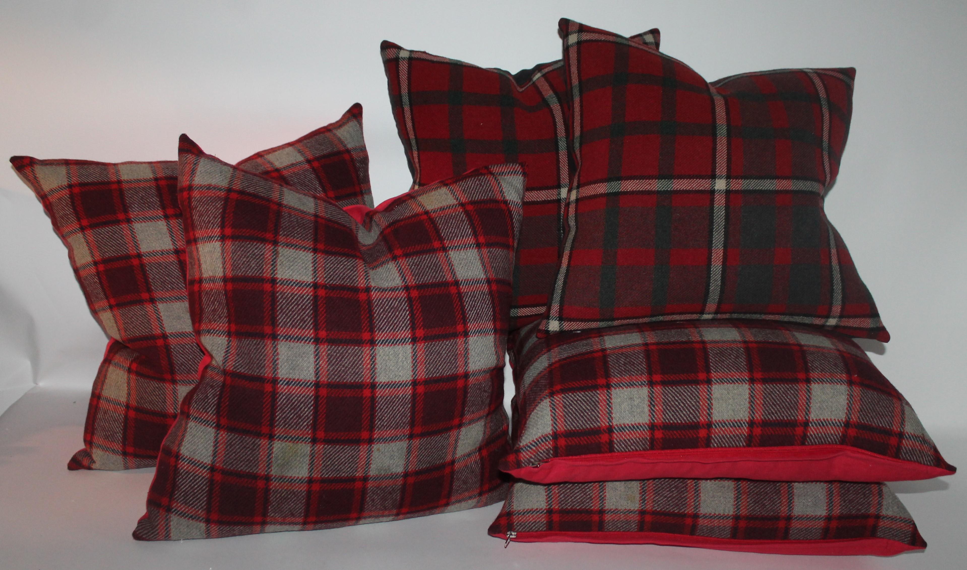 These two different colors and pattern pillows are in pristine condition and have cotton backing. Two pairs of each in stock. The larger are in burg., red and grey blanket with red cotton linen backing 22 x 22. 

The smaller plaid blanket pillows