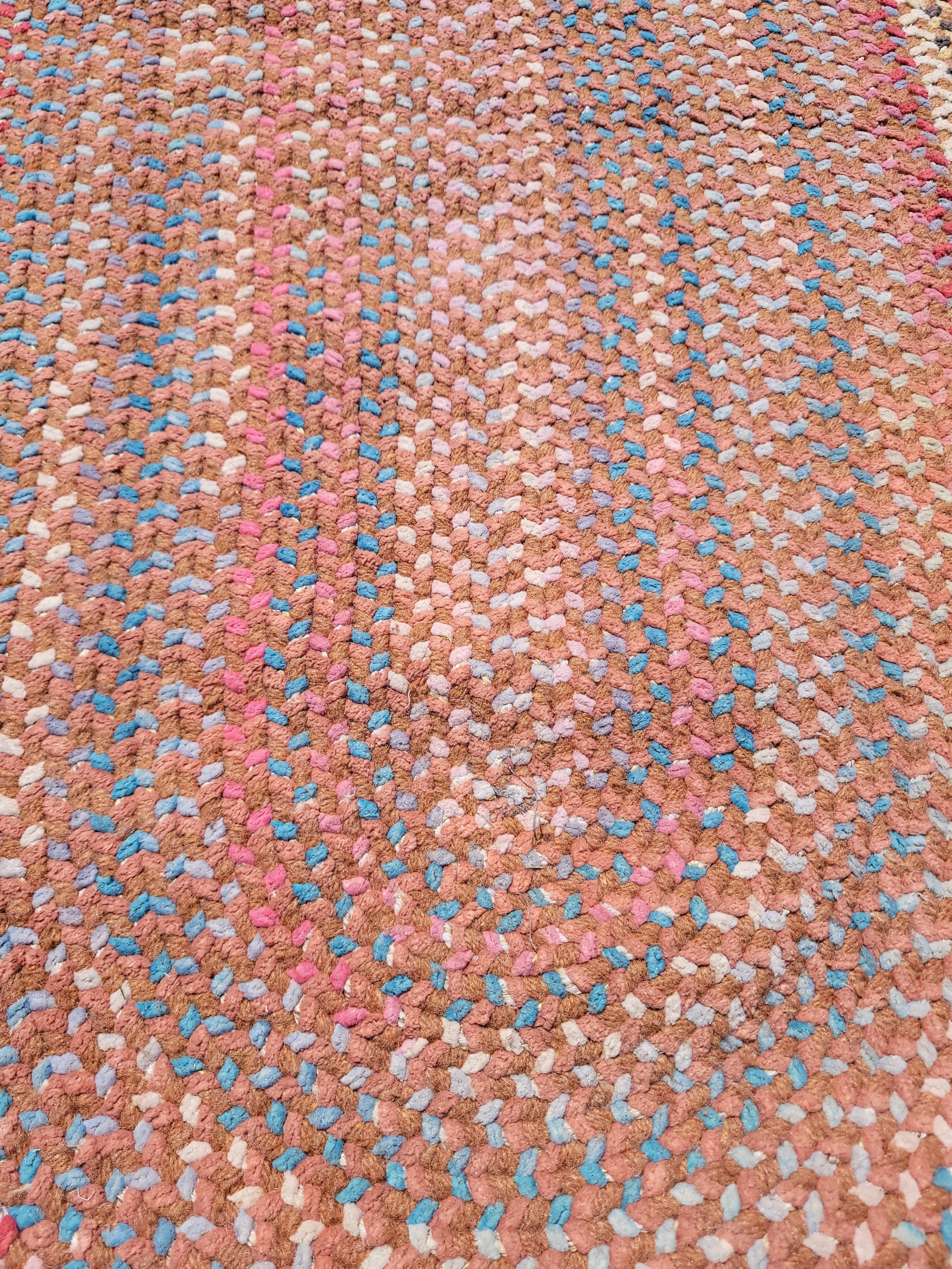 Amazing wool chenille oval braided rug in fantastic fall colors with a great sky blue trail border. The condition is pristine and vivid colors.