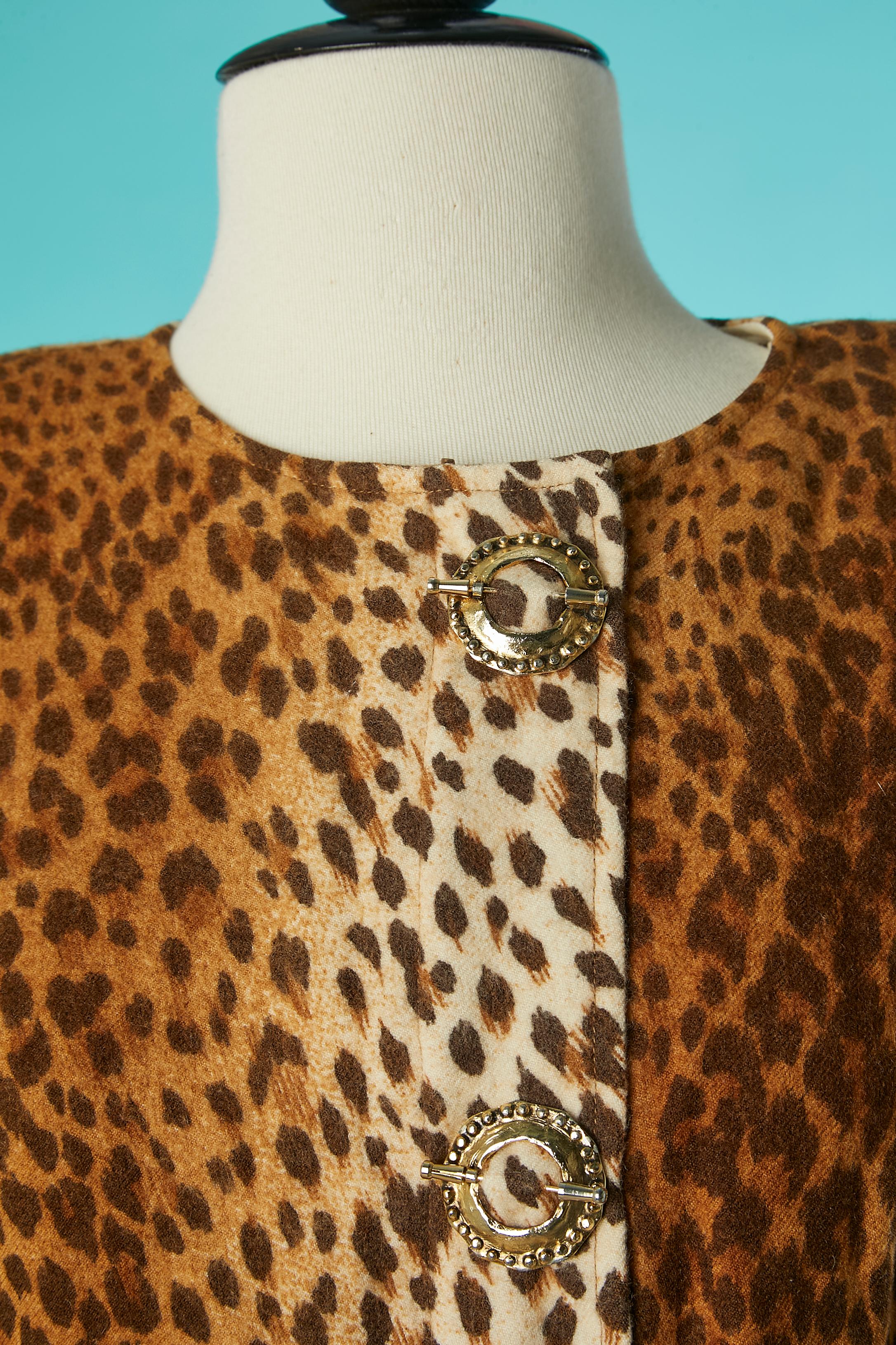 Wool cocktail dress with animal print and gold metal buttons. Snap closure under the  decorative buttons and zip closure underneath. 
Shoulder pad. 
SIZE 12 (US) L 