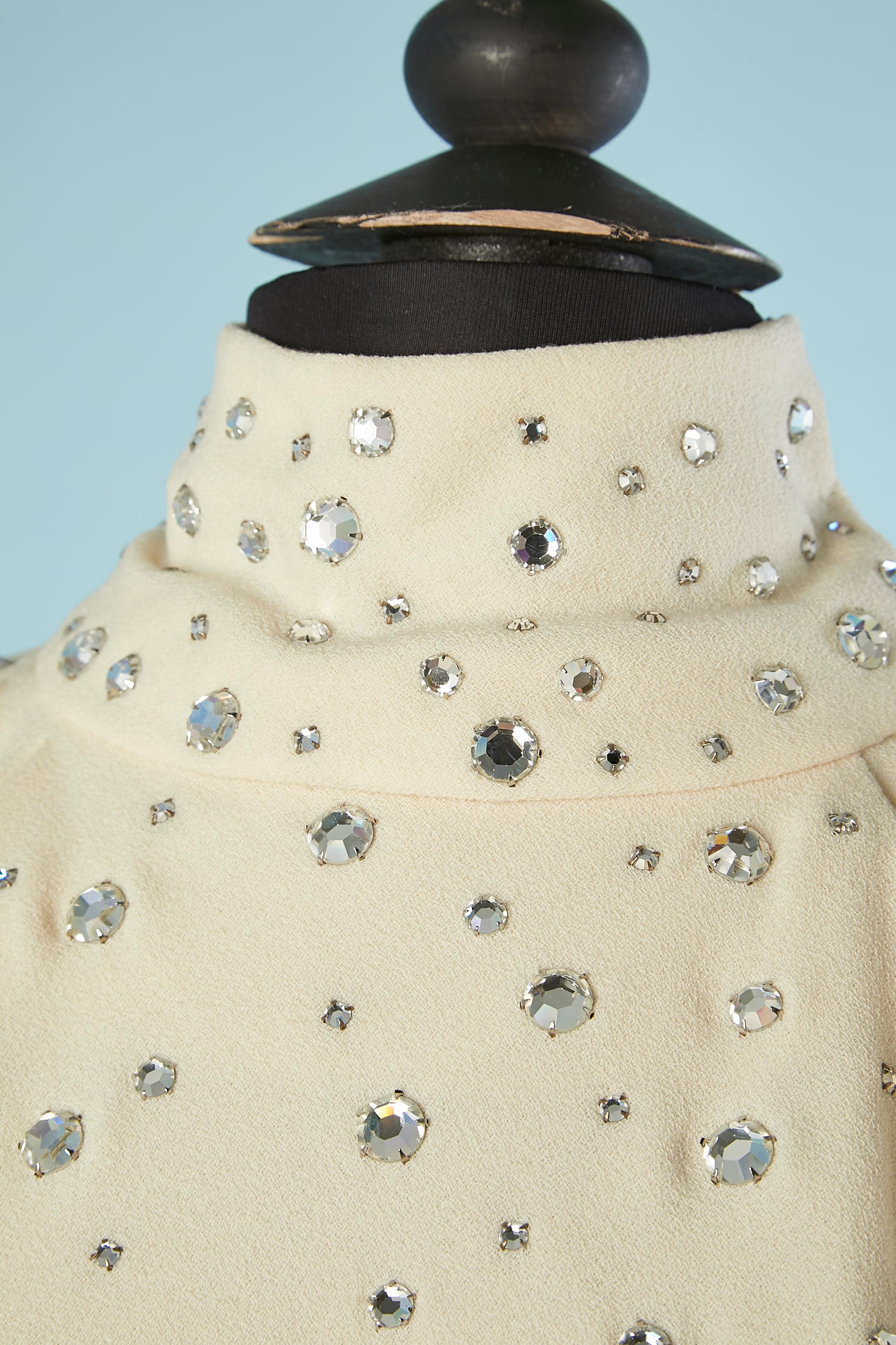 Wool-crêpe sleeveless cocktail dress with rhinestone. Zip and hook&eye middle back. Pauline Trigère (November 4, 1908 – February 13, 2002) was a Franco-American couturière. Her award-winning styles reached their height of popularity in the United