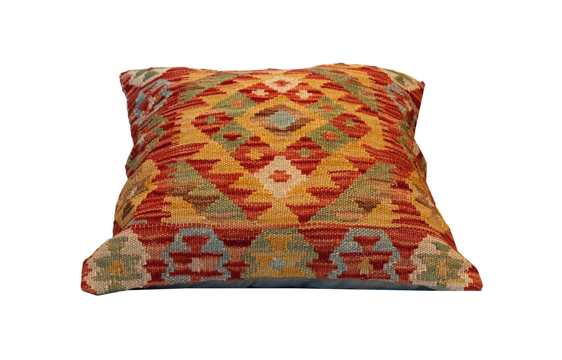 This truly unique geometric cushion cover is a handwoven kilim cushion cover woven in Afghanistan in the late 20th century/ early 21st century. Featuring a bold colour palette and geometric design made up of orange, brown, beige and green accents.