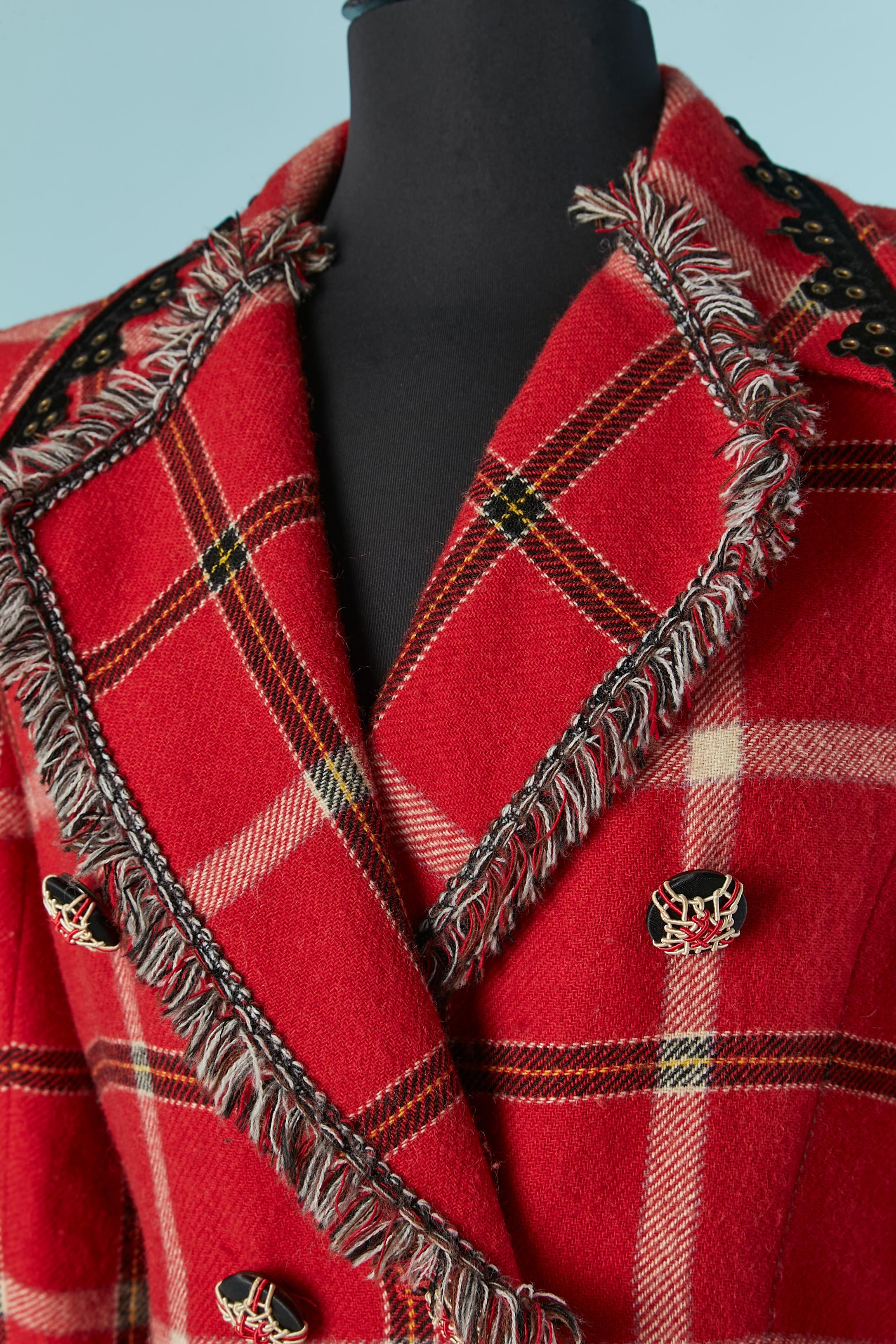 Veste en laine à double boutonnage avec motif écossais. L'étiquette de composition du tissu a été coupée mais la doublure jacquard est probablement en rayonne Détails en velours noir avec œillet. 
Bouton (recouvert de fil) et fermeture à la