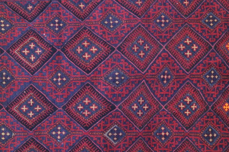 This Red wool rug is a fine example of an Afghani rug handmade by highly skilled Turkmen rug weavers in the north of Afghanistan. They have used hand-spun wool and 100% organic dyes for the production of these wool rugs. This tribal rug has