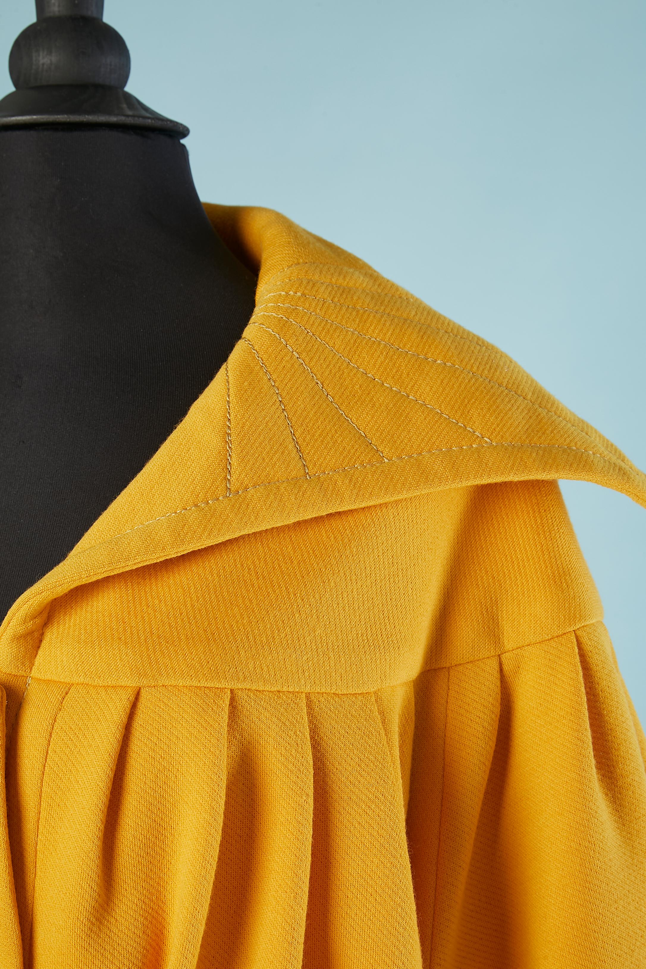 Wool jersey trouser and jacket ensemble with belt. Acetate or rayon yellow lining. Pleated on the bust and back. 3 buttons in the middle front and on cuffs. Top-stitched on the collar and on the side of legs. 
SIZE L 