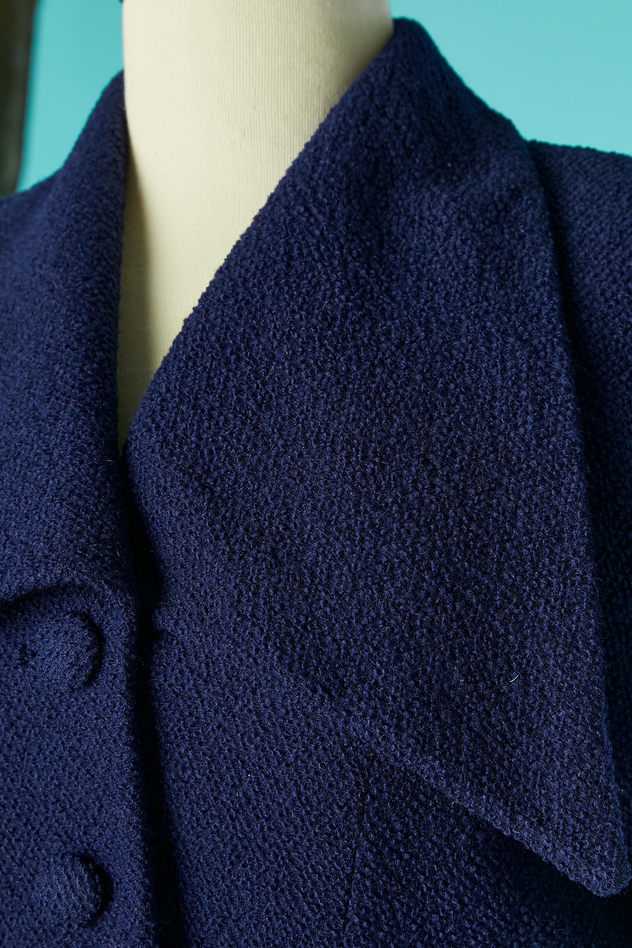 Costume jupe en laine bleu marine avec manches bouillonnantes. Doublure en rayonne (ou acétate) bleu marine. Bouton recouvert de tissu et boutonnière. Boutons en plastique et boutonnière aux poignets. Epaulettes. 
TAILLE M 