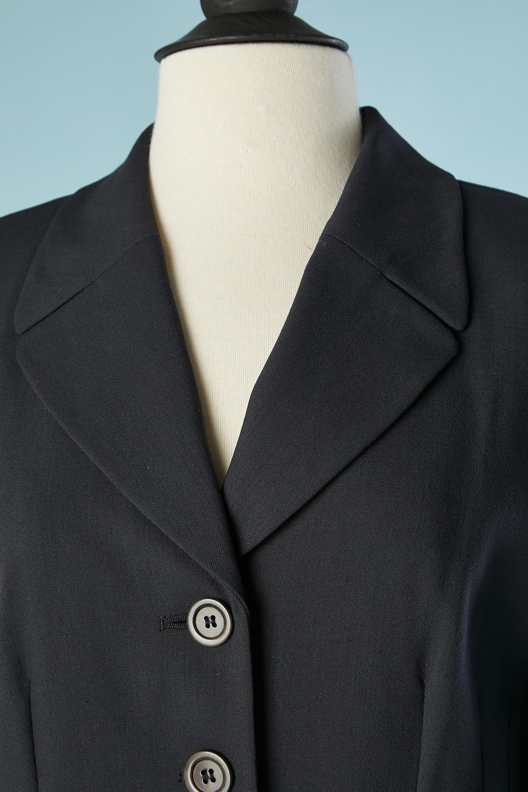 Wool navy blue trouser-suit (and skirt as well). Fabric composition: 100% wool. Lining composition: 100% Cupro ( sort of rayon) 
Shoulder pads .
SIZE 40 (Fr) 8 (Us) 