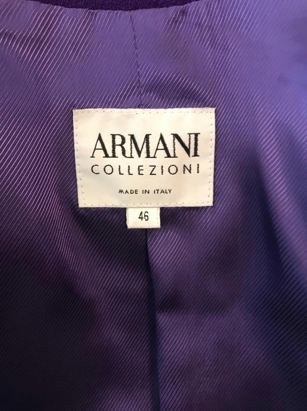 Deep purple wool jacket with shiny black patent trim from Armani Collezioni. Beautiful deep purple wool with patent trim along the collar, hemline, cuffs and pockets. Double breasted style with shiny black patent squared buttons spaced irregularly,
