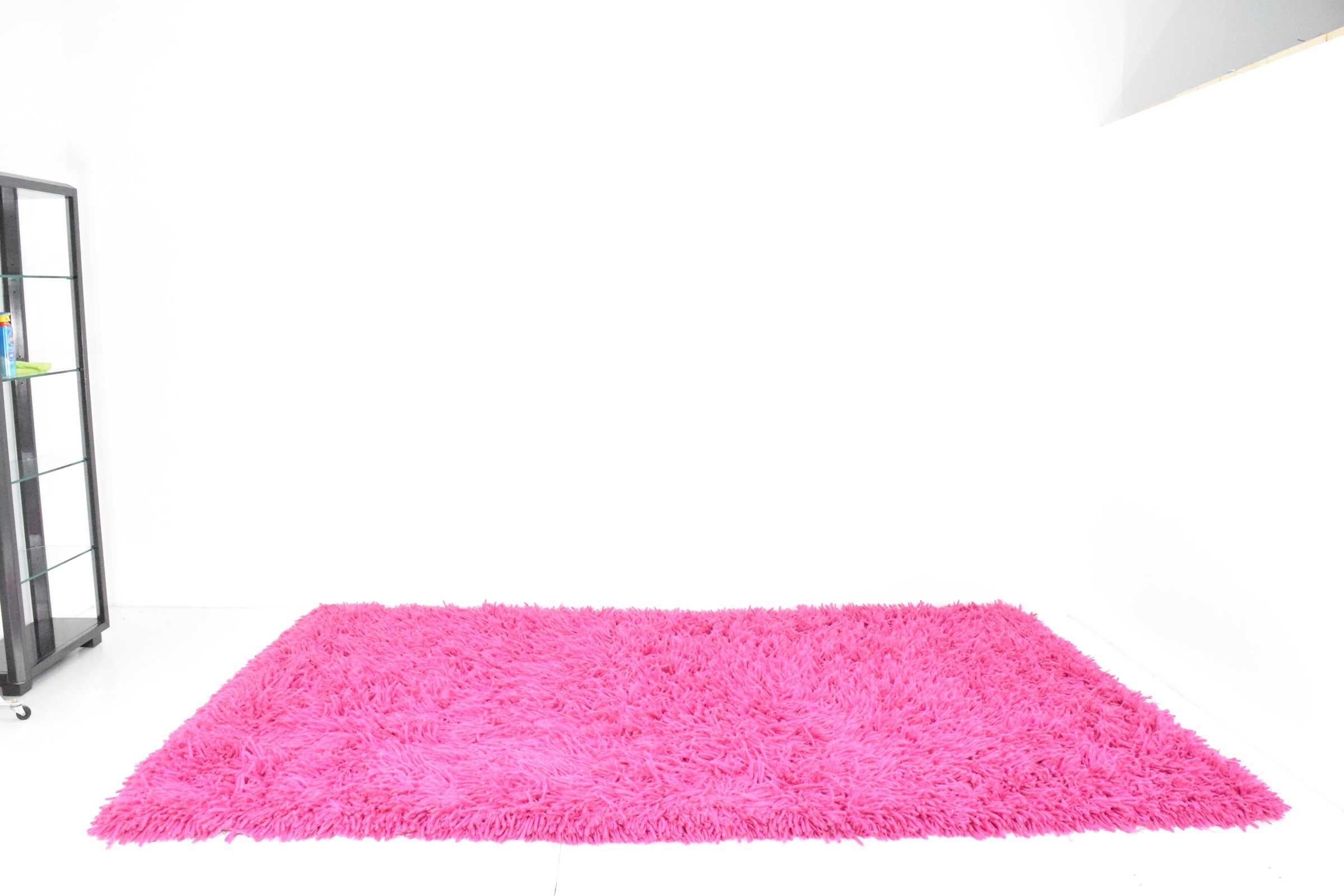 Rug is a bright, deep rich magenta. 100% wool. The Kilimanjaro rug by Creative Looms.