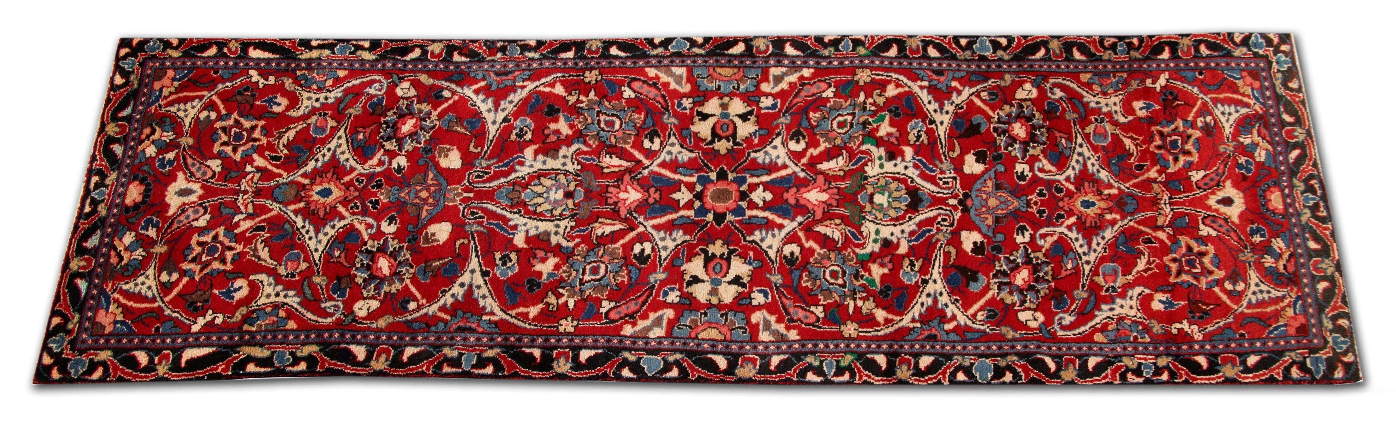 The central design has been intricately woven with a rich red background and blue, beige, cream and brown accents that make up the highly detailed symmetrical design. Featuring floral medallions throughout, this is then framed by a repeat pattern