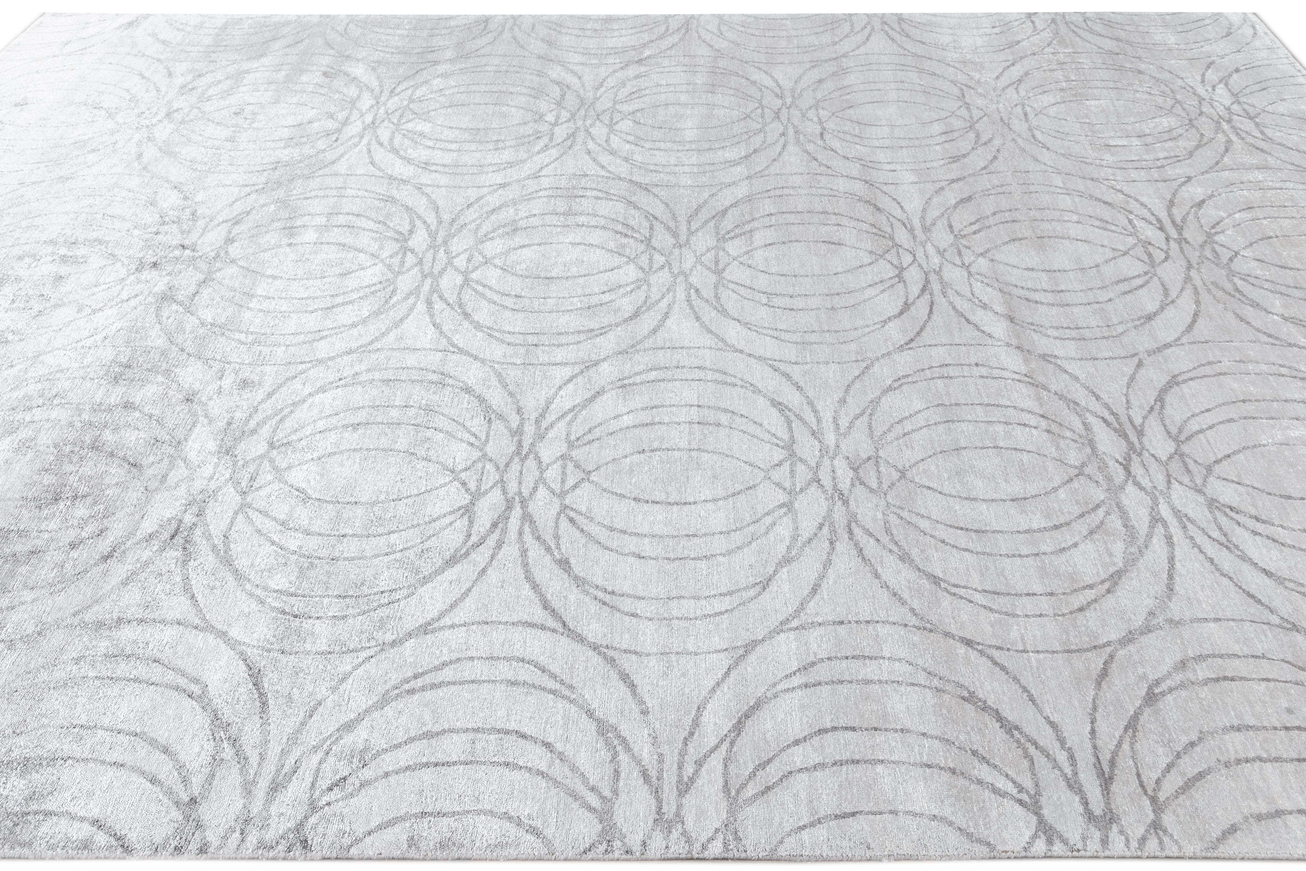This elegant rug, crafted from high-quality wool and silk, features an exquisite abstract design enhanced by sophisticated shades of deep gray, elegantly incorporating enchanting silver undertones.

This rug measures 9'1