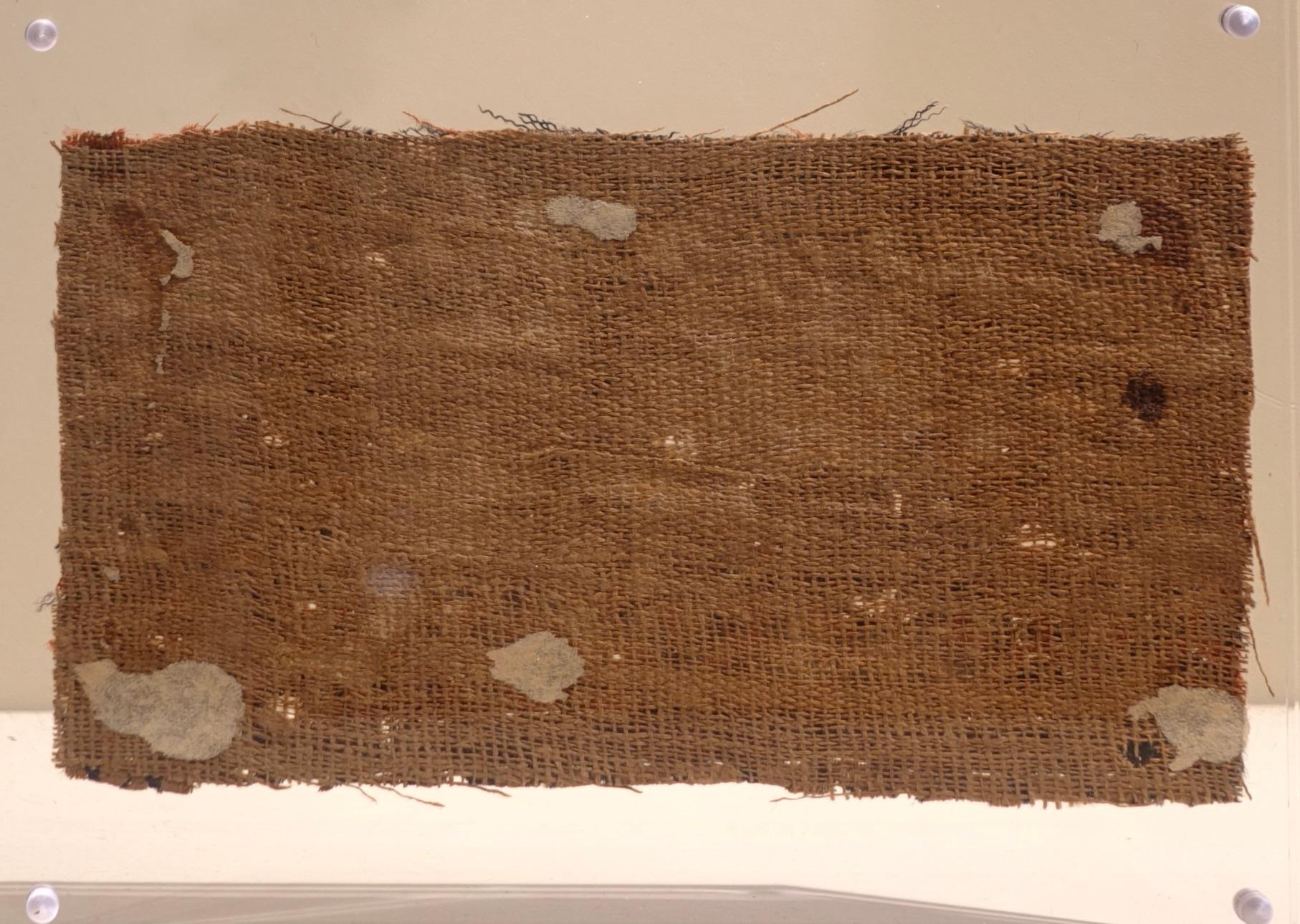 Wool Tapestry from Egypt
 Late Antique Period; 5th–7th Century C.E. 

This band fragment features geometric decorations in red and black.
Textiles like this are believed to have been crafted by Copts (Christian Egyptians) and other weavers