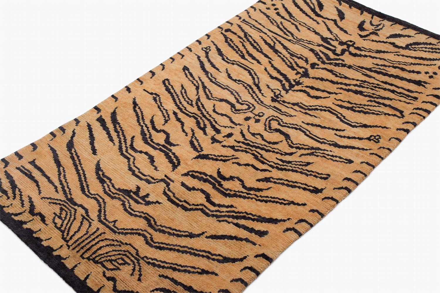This tiger carpet is a fresh take on an original Joseph Carini design. It has a textured weave, a Devi weave, 60 knot. It is 100% wool, hand-spun, and handwoven in Nepal. The abstract animal print is bold but not overwhelmingly so. Measures: 3' x