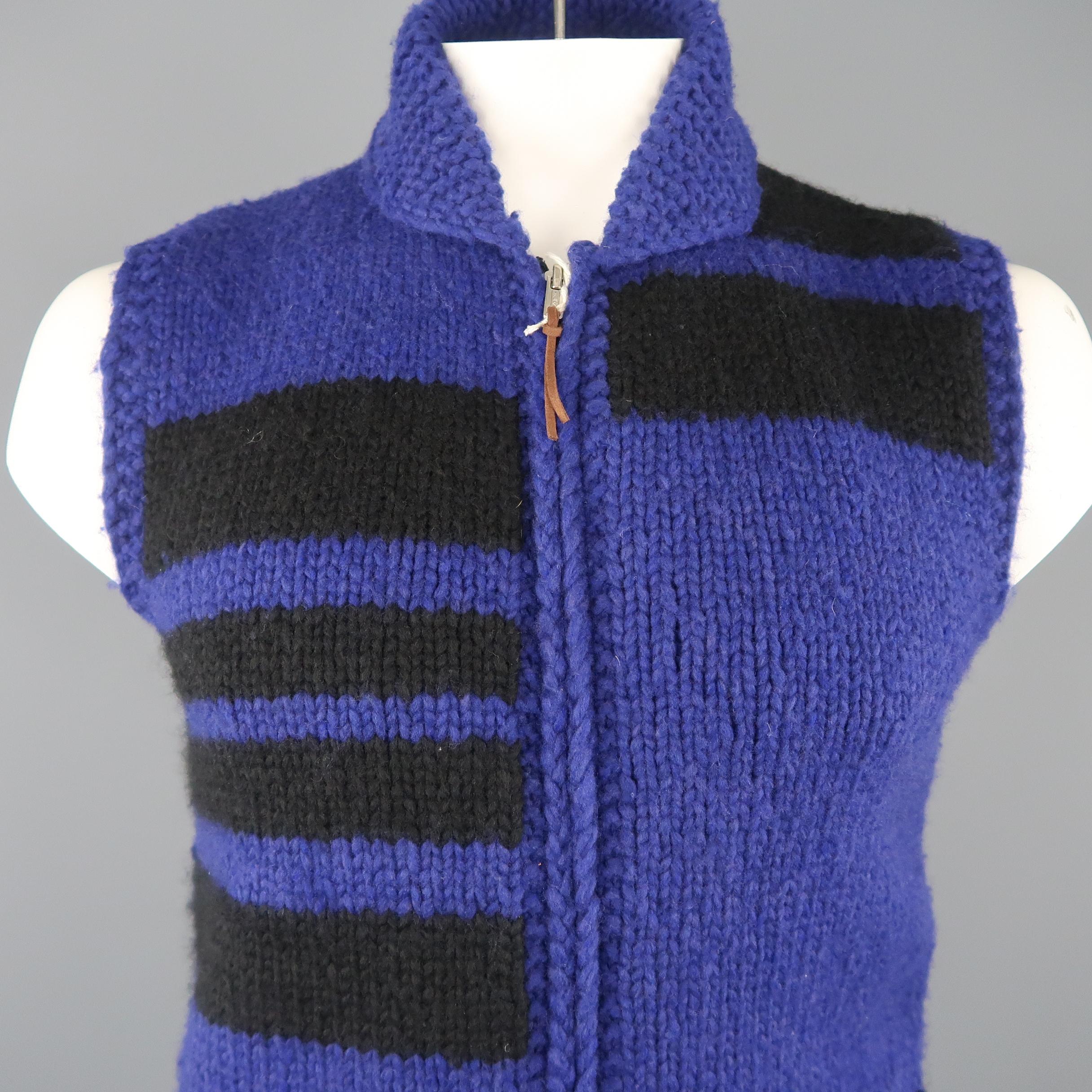 WOOLRICH vest comes in in purple knit with black geometric stripe pattern, shawl collar, patch pockets, and double zip front. Made in Canada.
 
New with Tags.
Marked: L
 
Measurements:
 
Shoulder: 17 in.
Chest: 42 in.
Length: 27 in.
