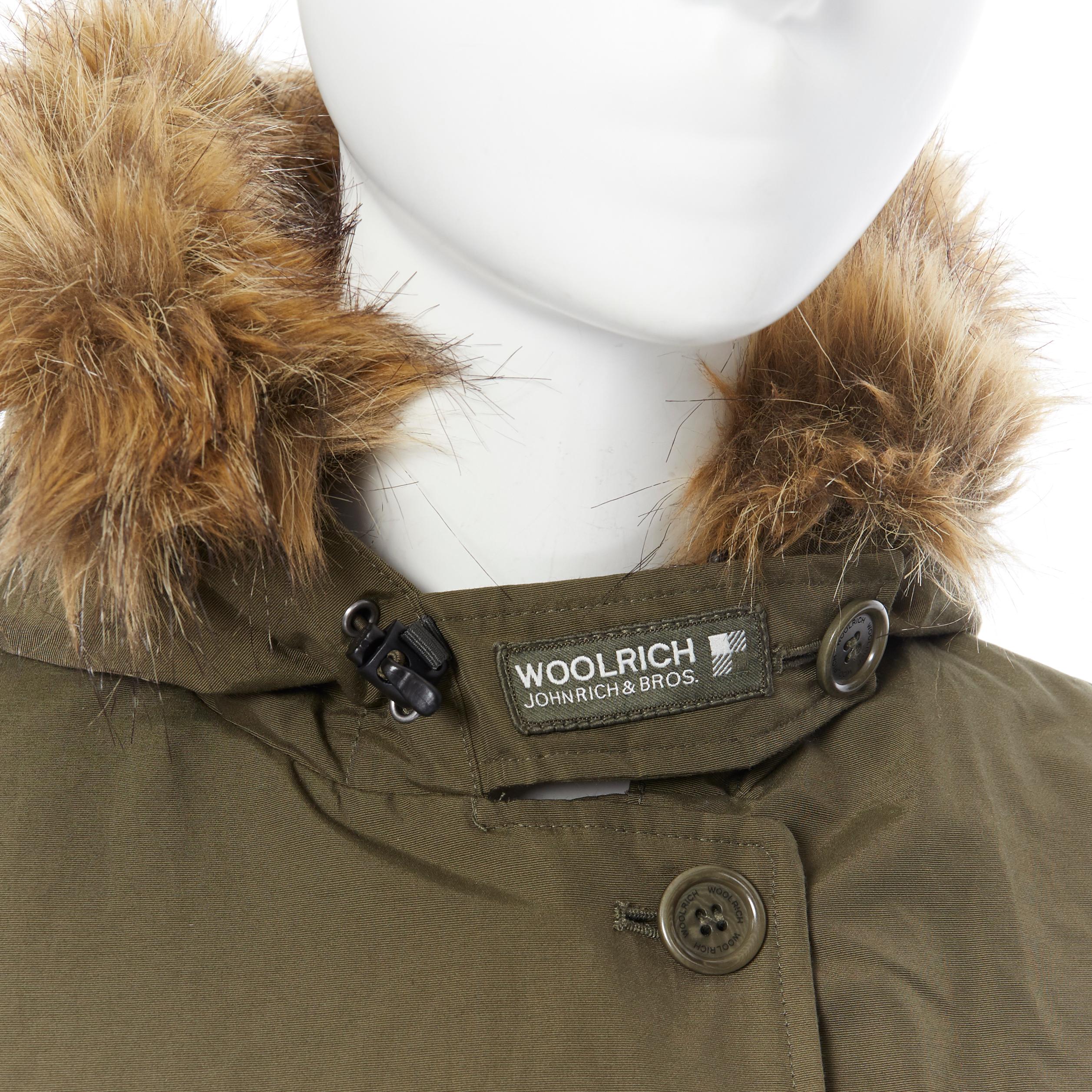 WOOLRICH olive green raccoon fur trimmed hood down padded winter coat jacket XS 
Reference: LNKO/A01205 
Brand: Woolrich 
Material: Cotton 
Color: Green 
Pattern: Solid 
Closure: Zip 
Extra Detail: Down padded. Ribbed cuff lining. Dual pockets on