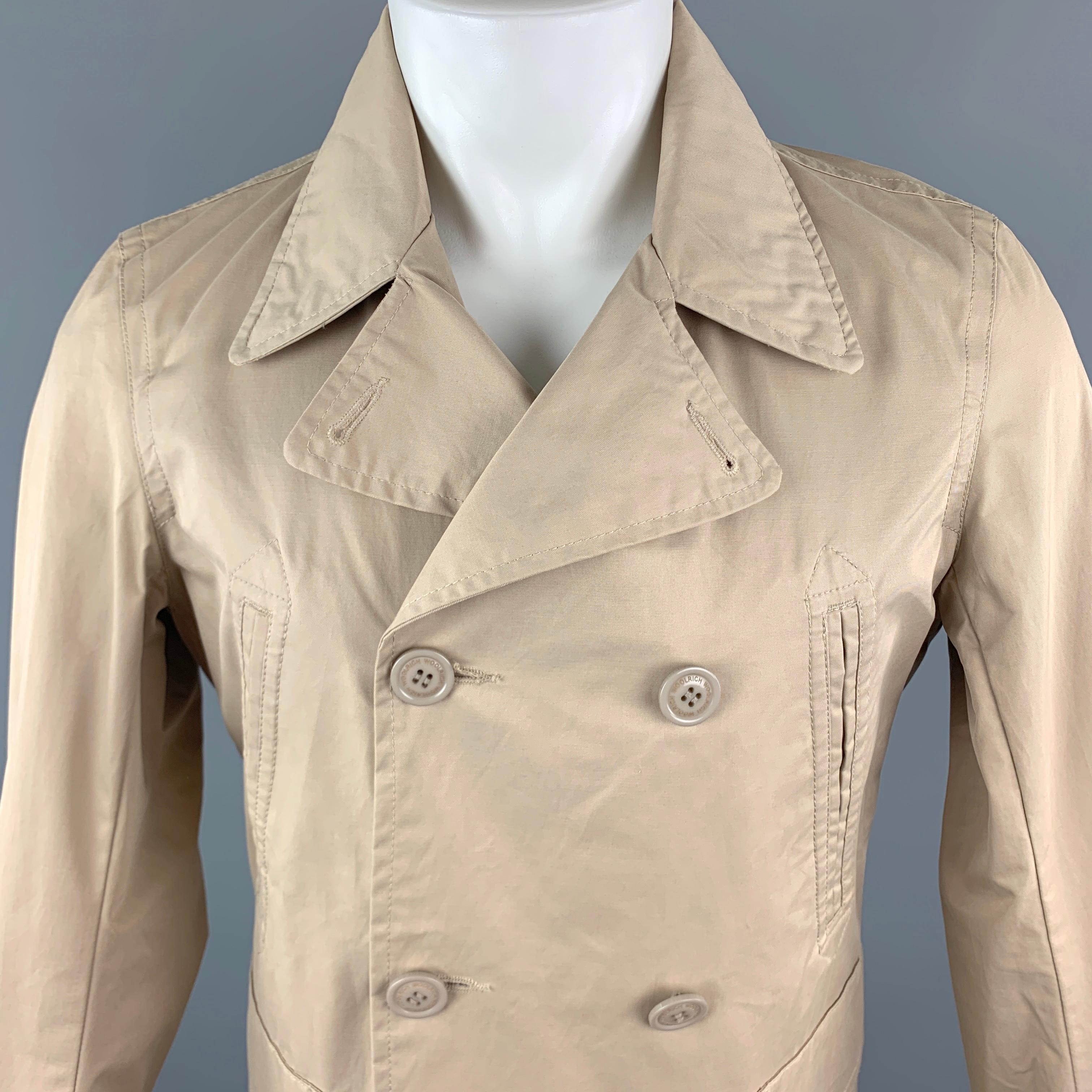 WOOLRICH Jacket comes in a tan tone in a solid cotton blend material, with a pointed collar, double breasted, with slit and patch pockets, functional buttons at cuffs, internal pockets, unlined. 

New With Tags.
Marked: S

Measurements:

Shoulder: