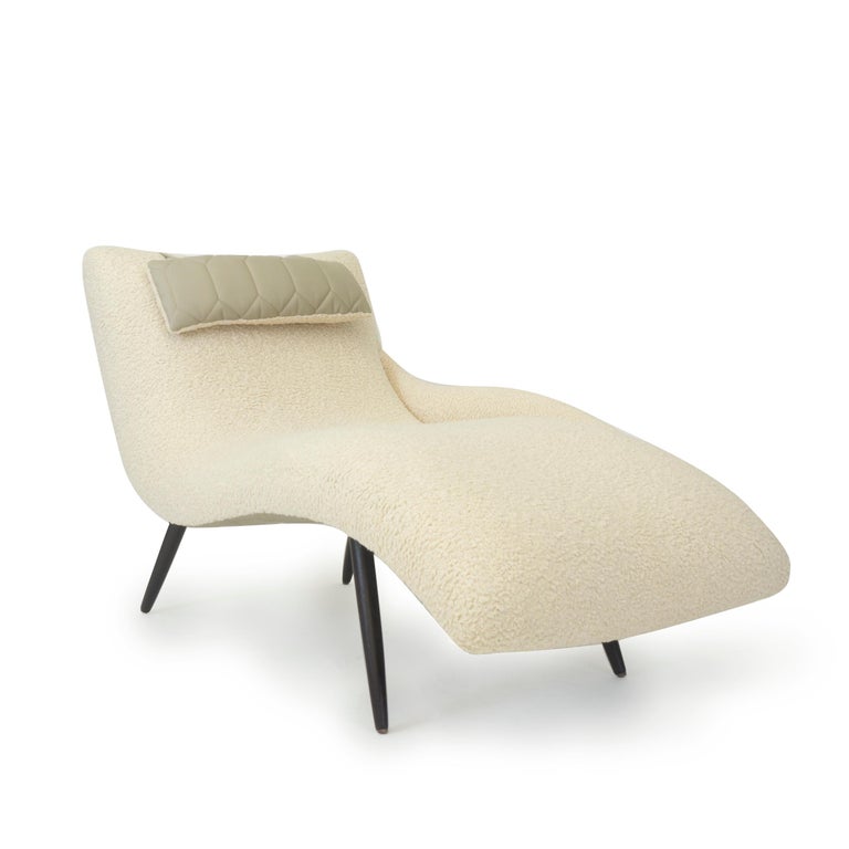 A lounge chair hand built by us in Norwalk, Connecticut upholstered in a wooly synthetic cotton fabric. This piece features a super comfortable sloping design for ultimate relaxation. This lounge chair also features exposed tapered legs, an attached