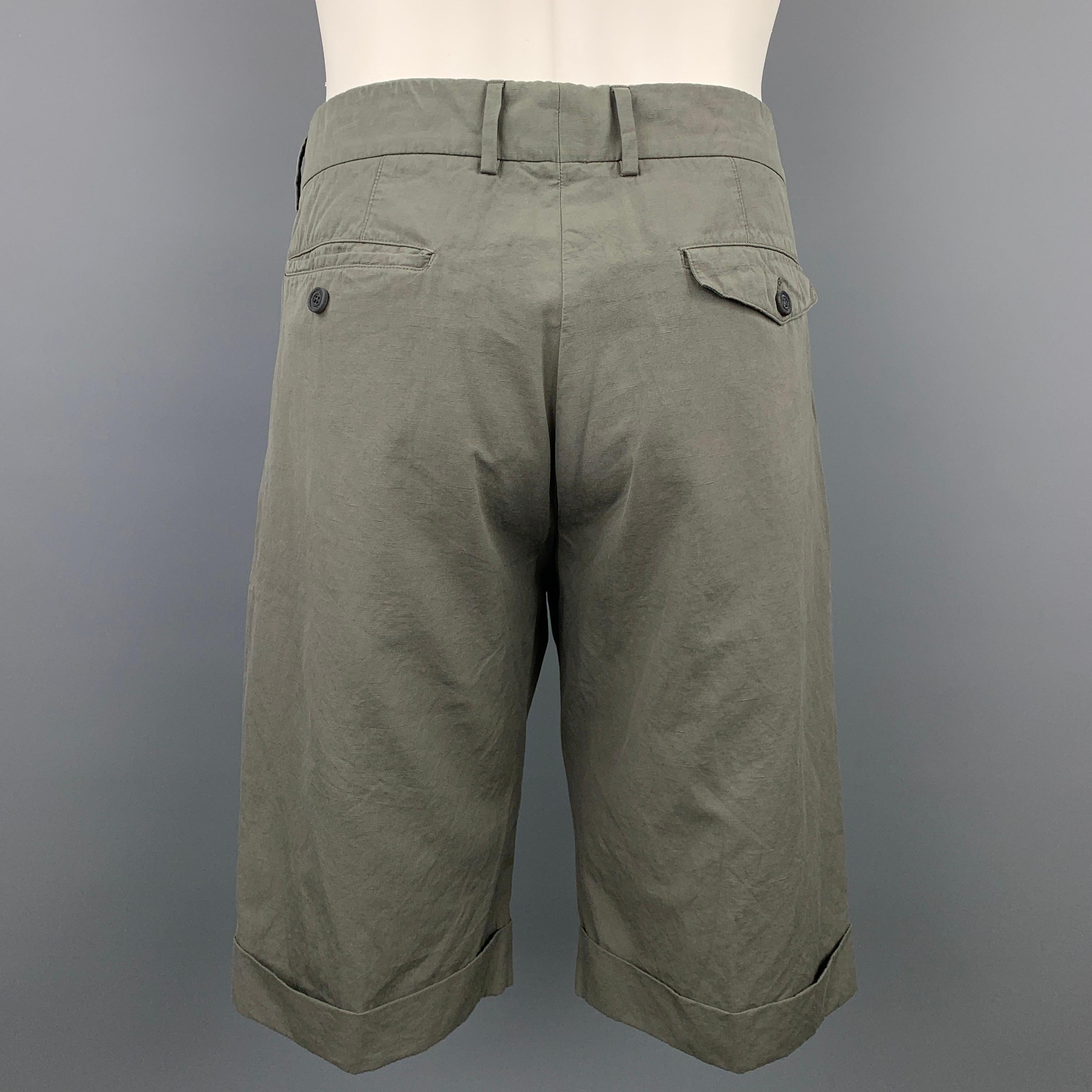 WOOSTER + LARDINI shorts comes in a olive cotton featuring a pleated style, belted, cuffed leg, front tab, and a button fly closure. Made in Italy.

Very Good Pre-Owned Condition.
Marked: 48

Measurements:

Waist: 34 in.
Rise: 11 in.
Inseam: 14 in.