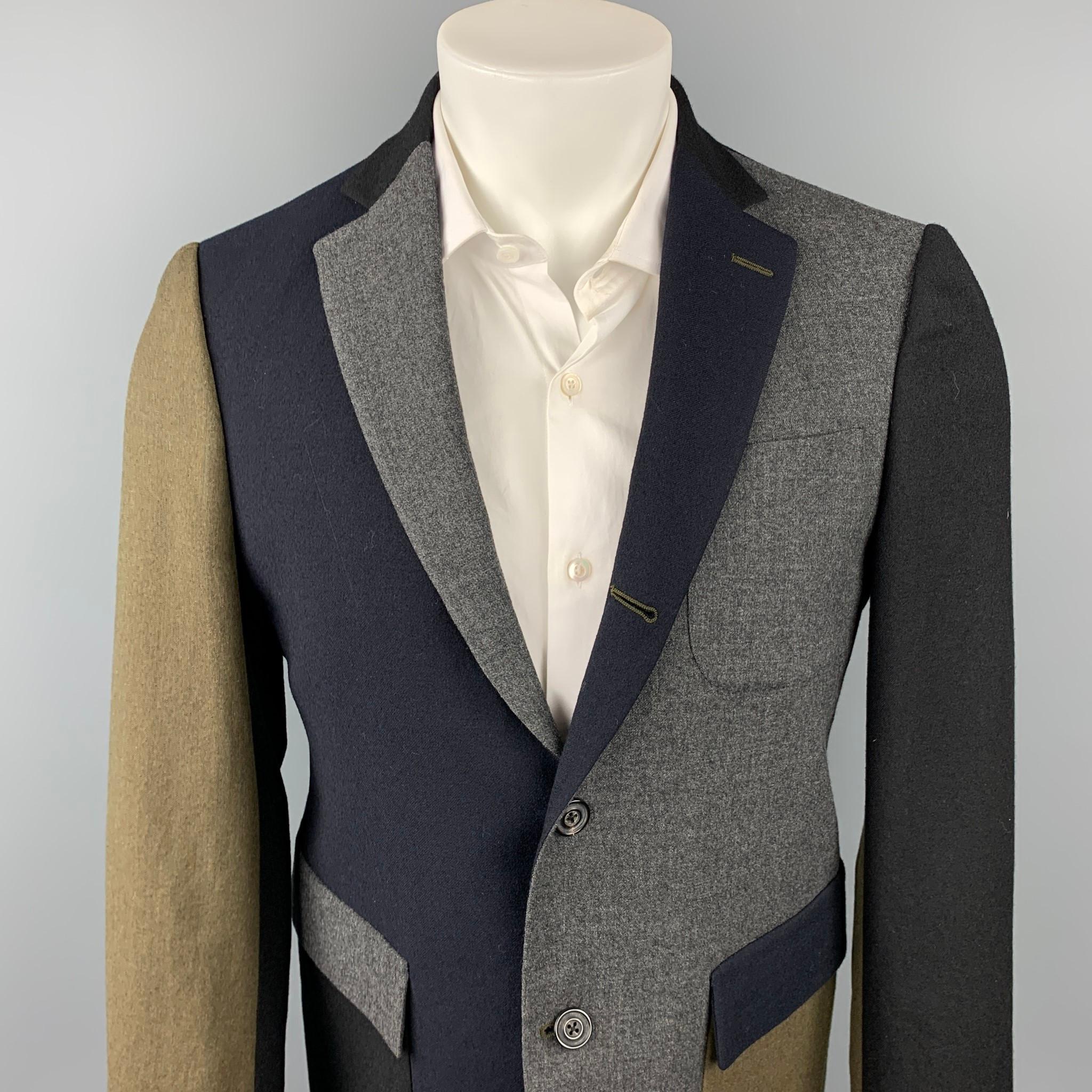 WOOSTER + LARDINI sport coat comes in a navy & grey color block wool with a full liner featuring a notch lapel, flap pockets, and a three button closure. Made in Italy.

Very Good Pre-Owned Condition.
Marked: IT 48

Measurements:

Shoulder: 17.5