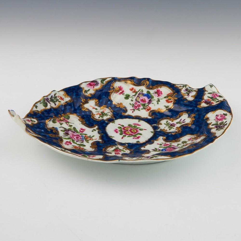 Worcester Blue Scale Leaf Dish, c1775

Additional information:
Date : c1775
Period : George III
Marks : Worcester pseudo fret square
Origin : Worcester, England  
Colour : Polychrome, blue ground
Pattern : Blue scale with floral panels 
Features: