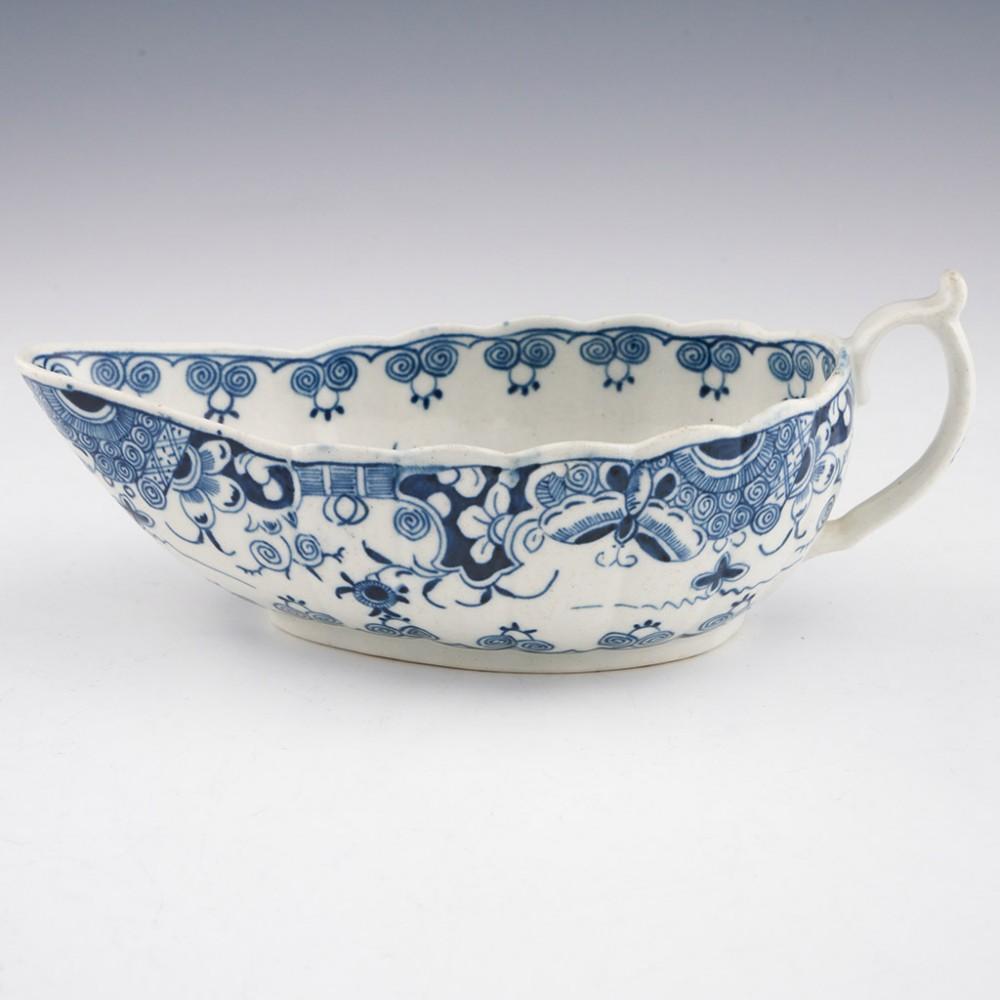 Heading : Worcester doughnut tree pattern sauce boat.
Date : 1775-1780
Period : George III
Marks : none
Origin : Worcester; England
Colour : underglaze blue
Pattern : Doughnut Tree pattern; the decoration to the exterior of the sauce boat is
