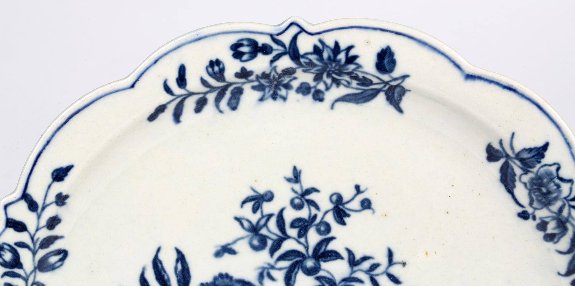 A fine antique Worcester early large Dr Wall period blue and white pine cone pattern plate dating from circa 1760. The rounded plate has a raised shaped rim and decorated with pine cones set amidst flowers with floral designs applied around the rim.