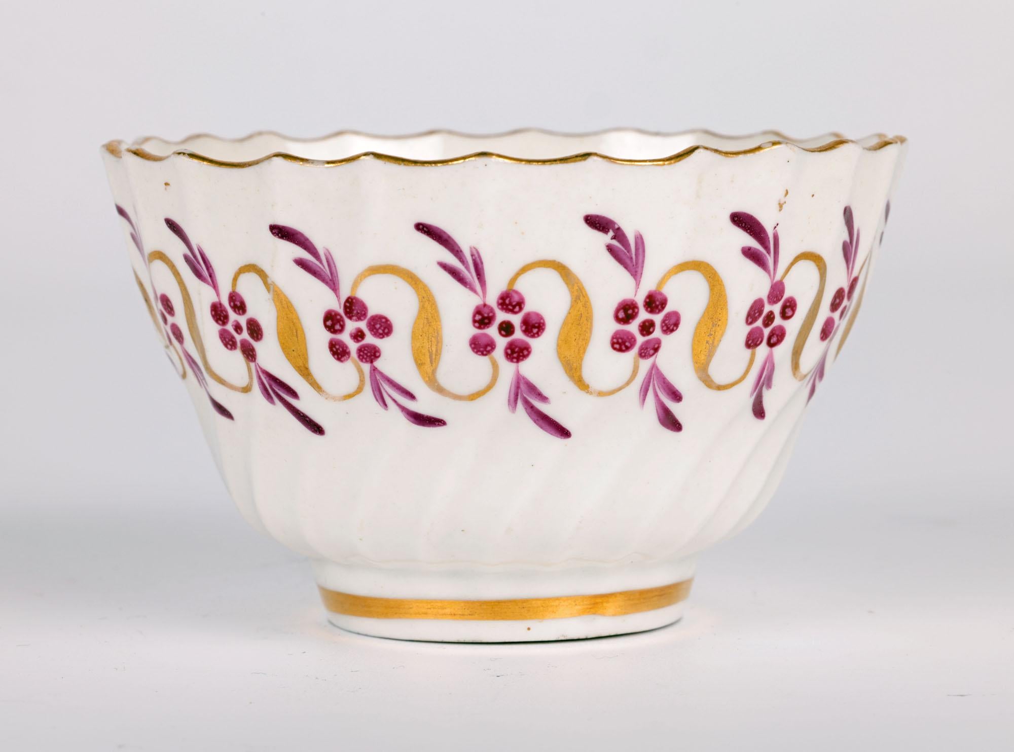 A rare and early antique English hand painted porcelain tea bowl and saucer made by the renowned Worcester Flight factory and dating from around 1780. The tea bowl and saucer are made in white porcelain with a matching ribbed patterning to the