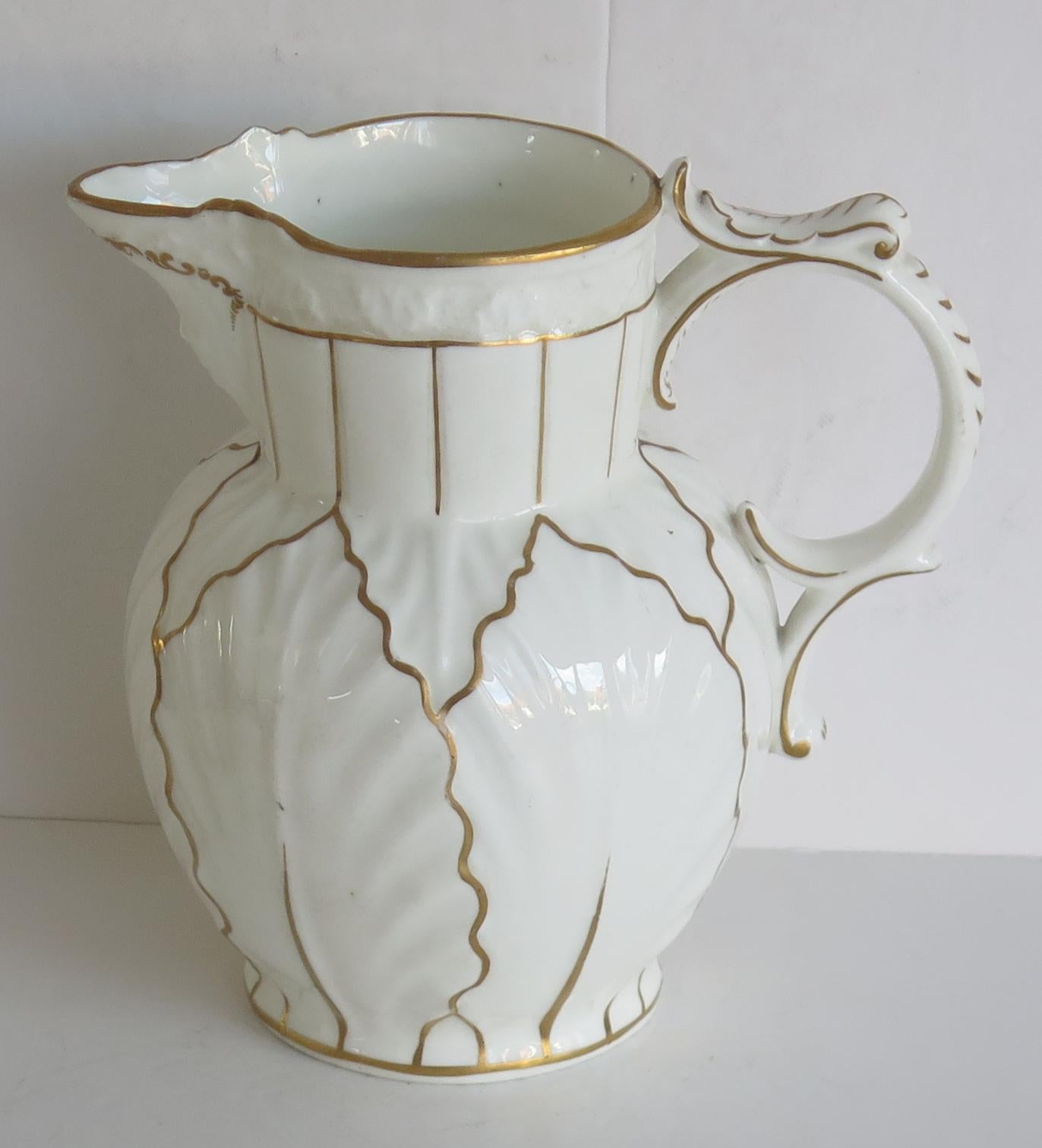 This is a good Cabbage Leaf moulded mask head, porcelain Jug or Pitcher, which we attribute to Worcester, made in the early 19th Century.

This is a mask spouted jug with cabbage leaf moulding and a distinctive loop handle.

The jug has a