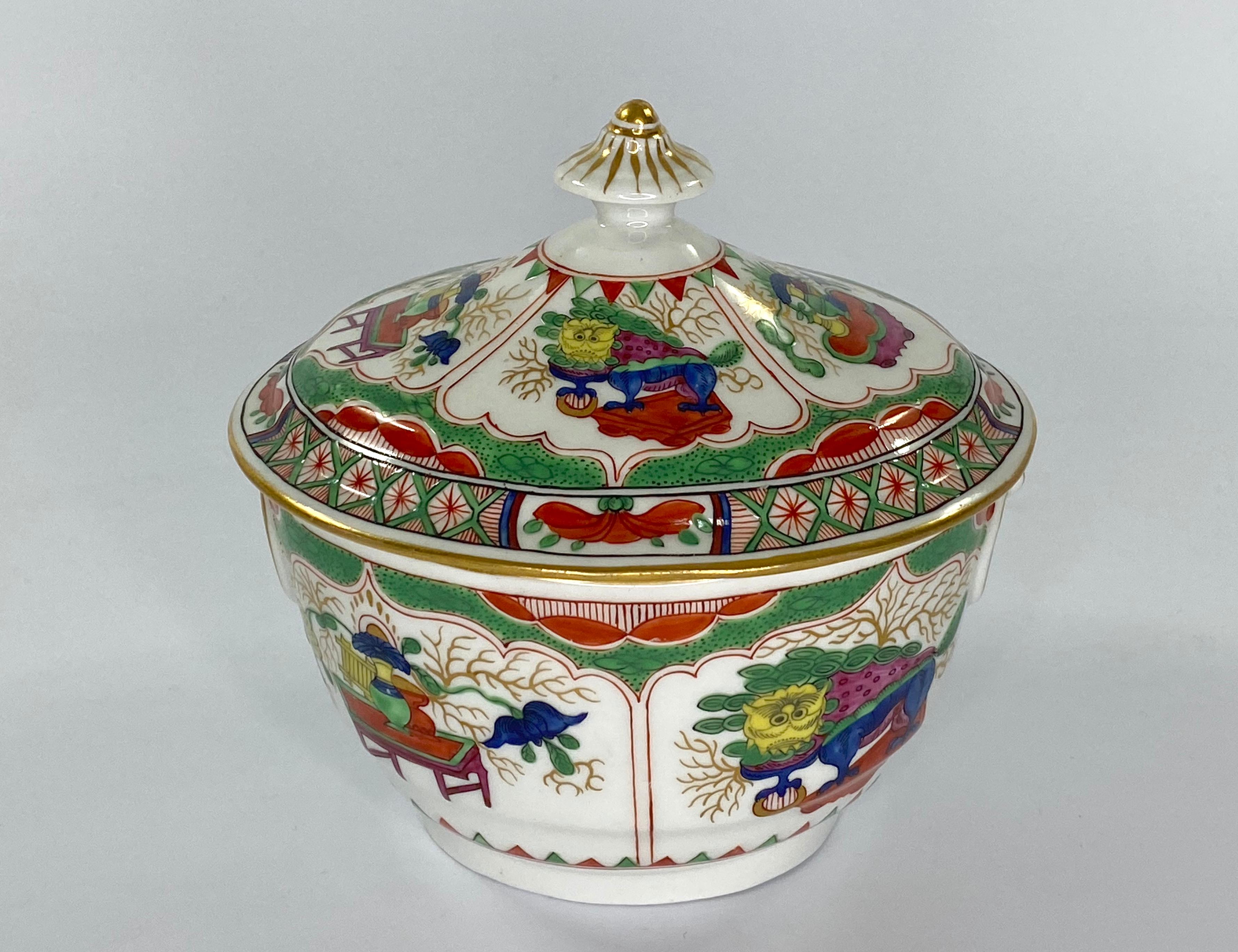 Worcester porcelain sucrier and cover, c. 1795, Barr period. The oval sucrier, well painted in vibrant enamels, with the ‘Dragons in Compartments’ pattern. Having twin moulded ring handles, heightened in gilt.
The cover similarly painted, and