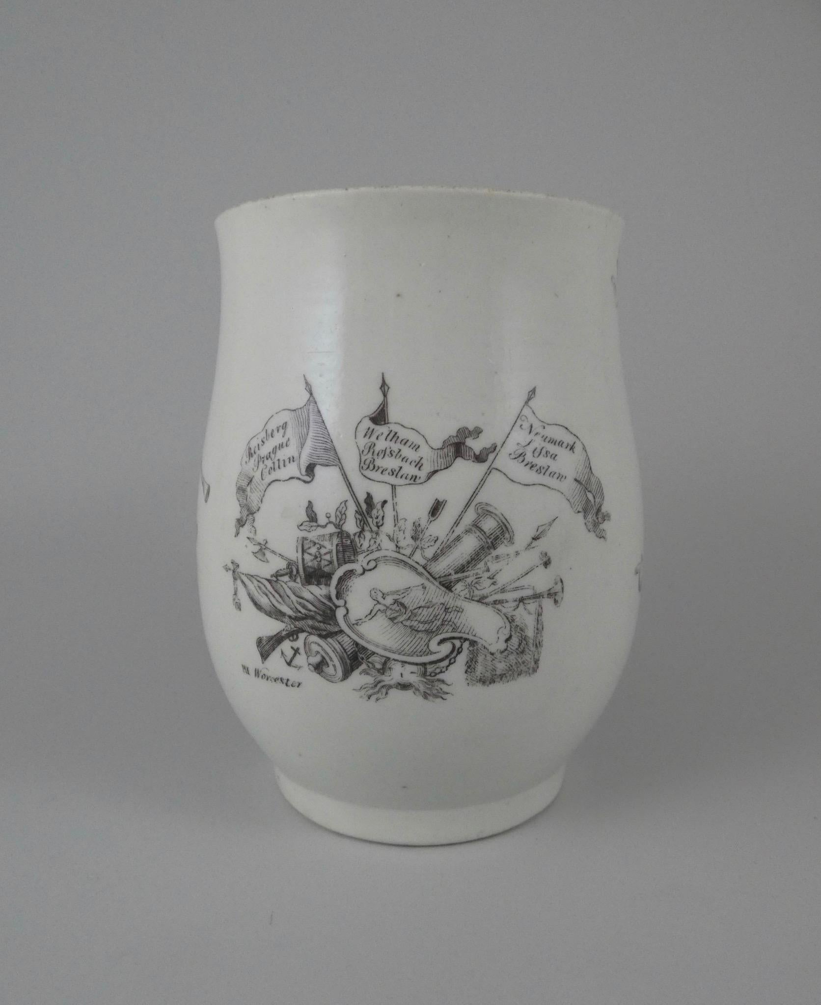 A fine and large Worcester porcelain bell shaped mug, circa 1757. Printed with a portrait of the King of Prussia, pointing towards trophies of war, and flags inscribed with the names of his battles. The reverse with a figure of ‘Fame’. Having a