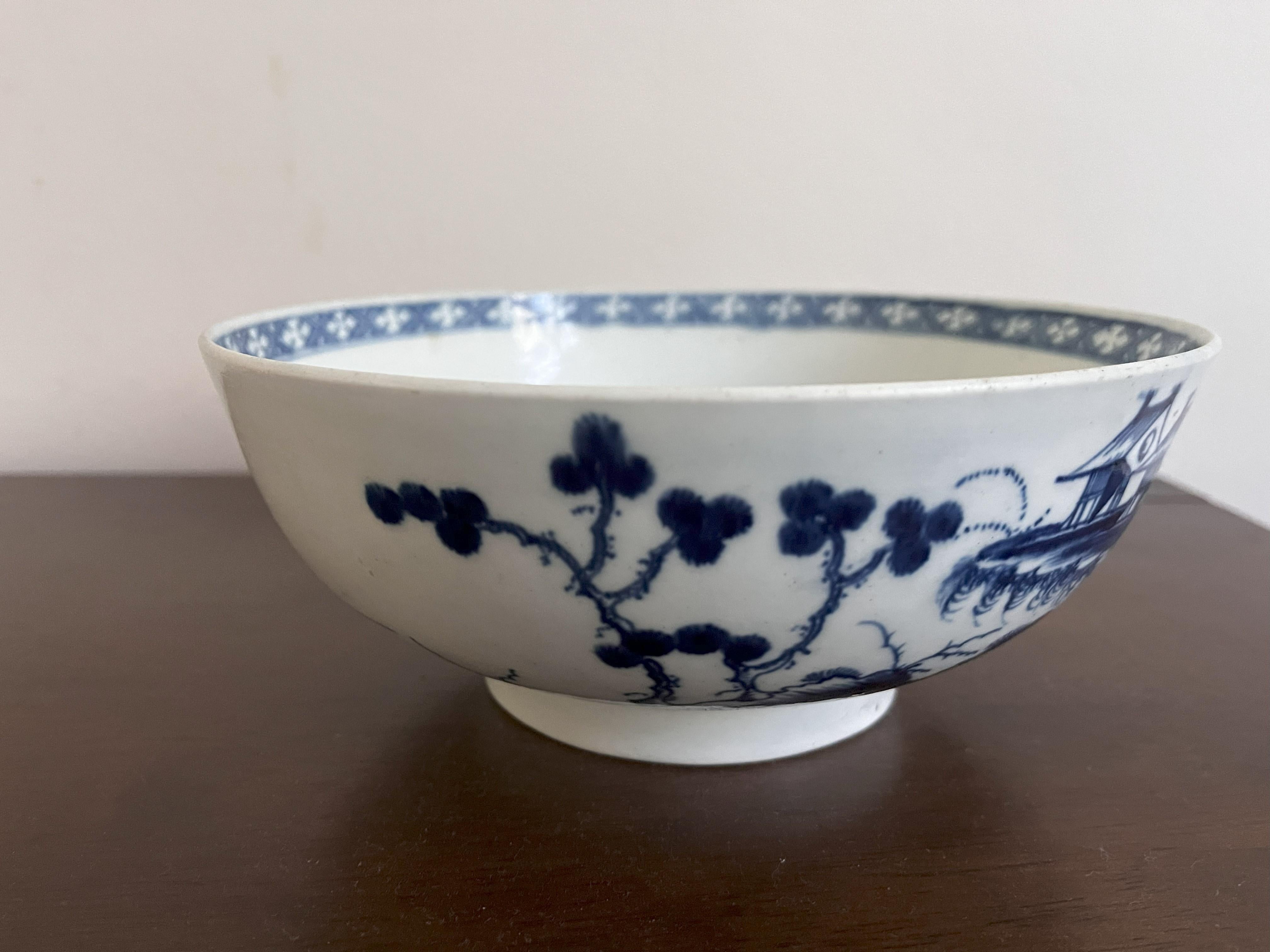 Large Worcester punch bowl, well painted in blue with a version of the Precipice pattern, with several pavilions scattered across the continuous landscape of islands, the interior with a similar scene to base with lattice border at the rim. Circa