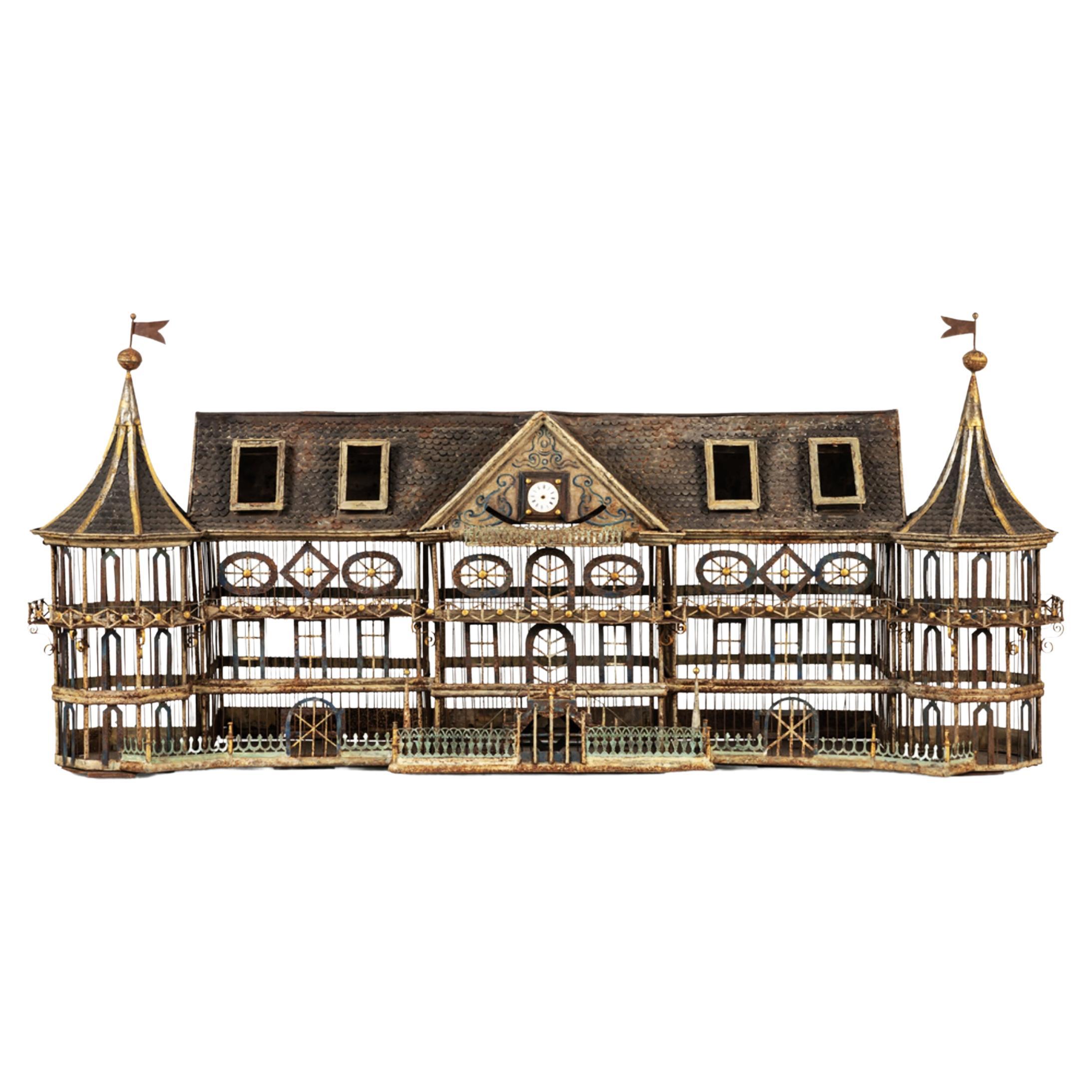 Exceptional sized, this wonderful large vintage birdcage is made of serrated cut iron with decorative friezes all in finesse and delicacy, enhanced with colors and gold. The shape of a fantasy castle pavilion with two side towers topped by flags. In