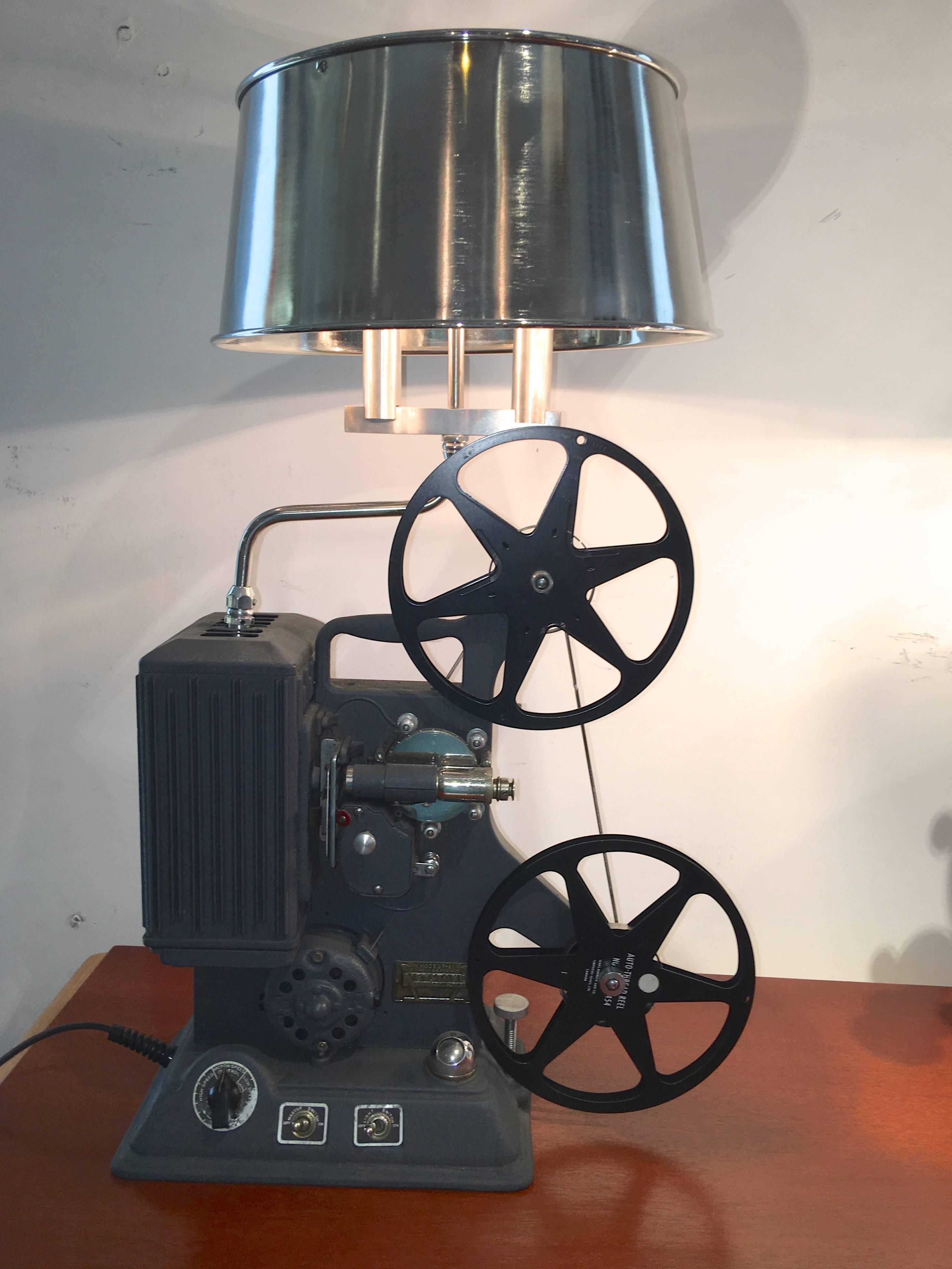 Fully operational 1939 Model R-8 8mm film projector by Keystone Manufacturing Company of Boston, MA which has been converted into a table lamp with machined and polished aluminum hardware and lamp works and a polished stainless steel lampshade.