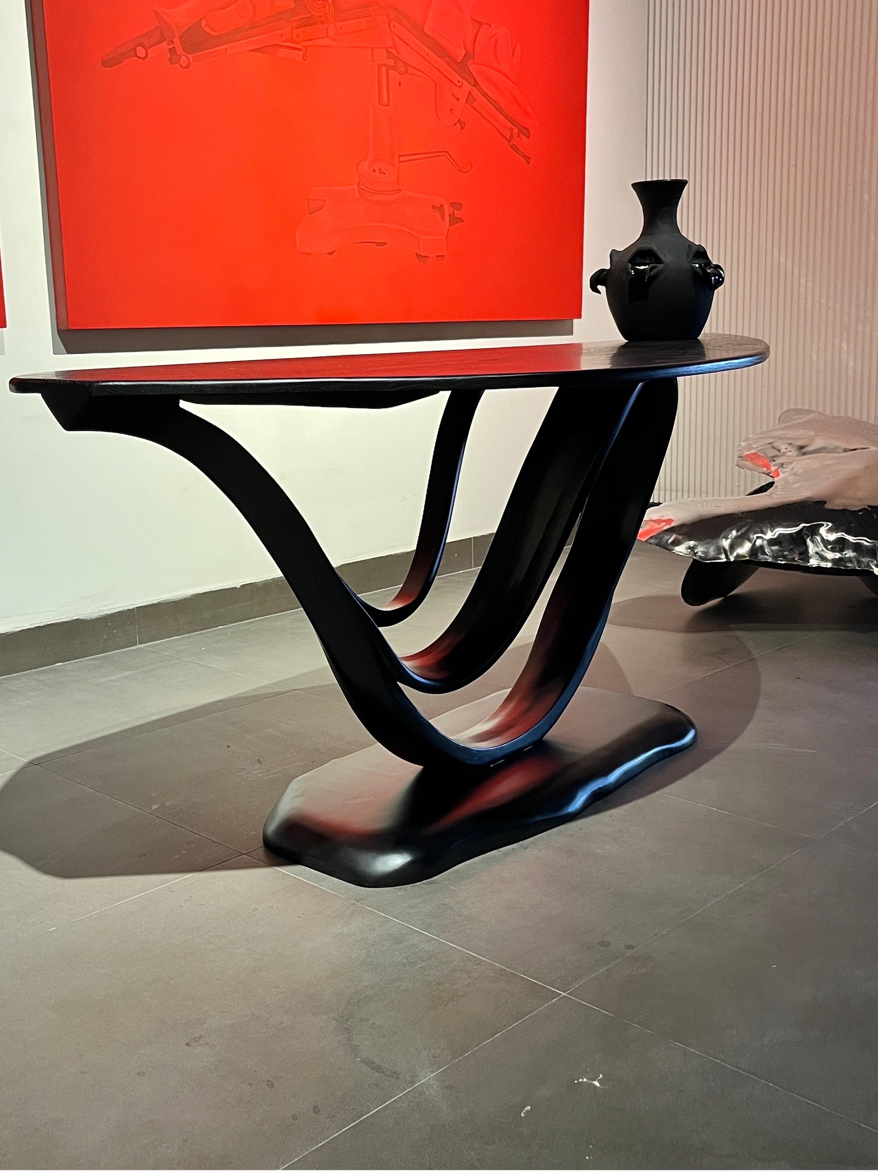 This is the Working Desk No. 1 of the Studio's Fluentum Series.

The construction of the table is a clean design; showcasing details and flows of a bent-wood design. Wood emerges smoothly from the structure to create a harmonious flow; following the