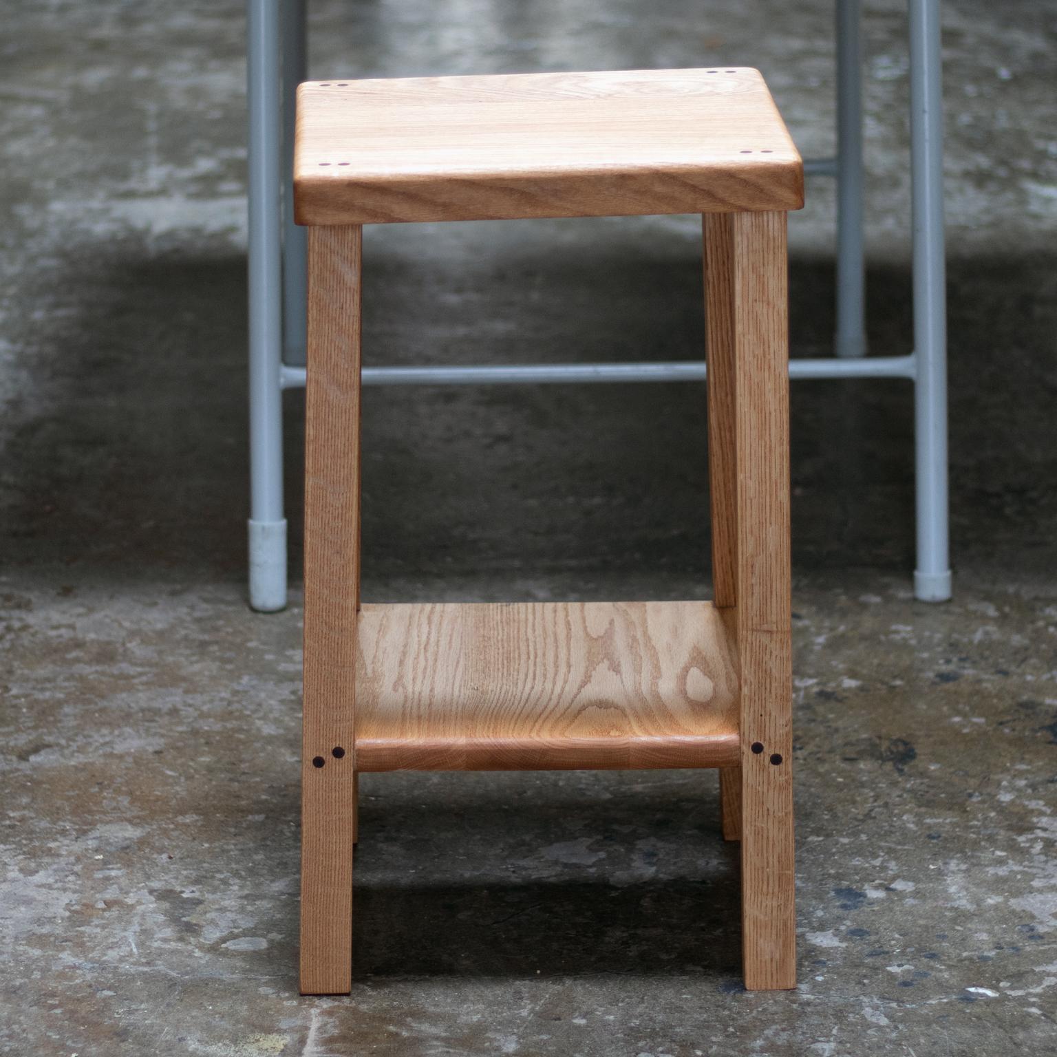 This bar stool features thick stock walnut seat and solid oak frame. 
Using walnut dowel joinery, these stools balance heft and elegance.
These stools are substantial pieces with subtle details, quality construction, and high design.

Finished