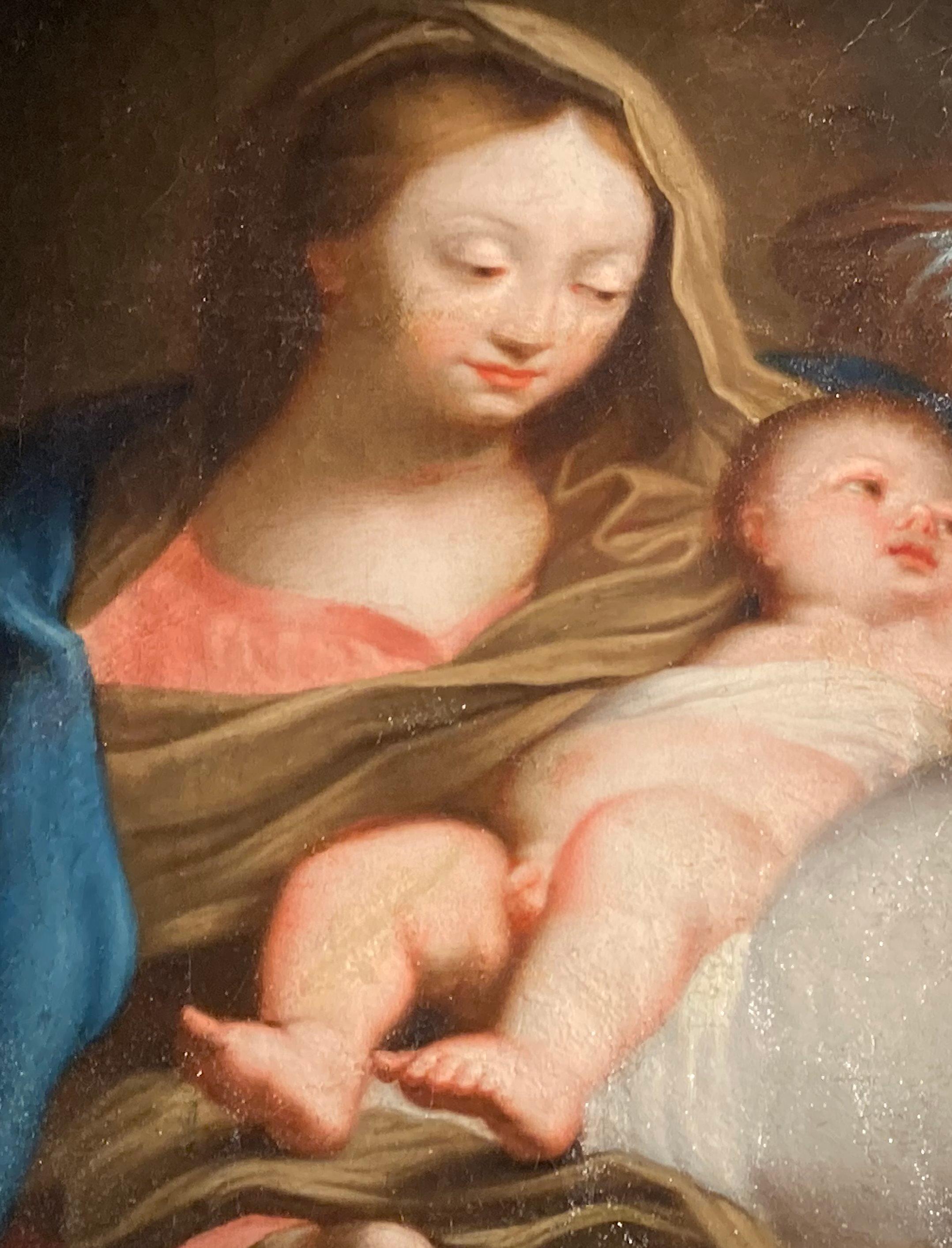 Peinture religieuse, représentant la Vierge et l'Enfant, entourés d'anges par le cercle de Carlo Maratta (Maratti). Cette peinture est un merveilleux exemple d'une scène d'adoration romaine typique. Pour des raisons stylistiques, elle peut être