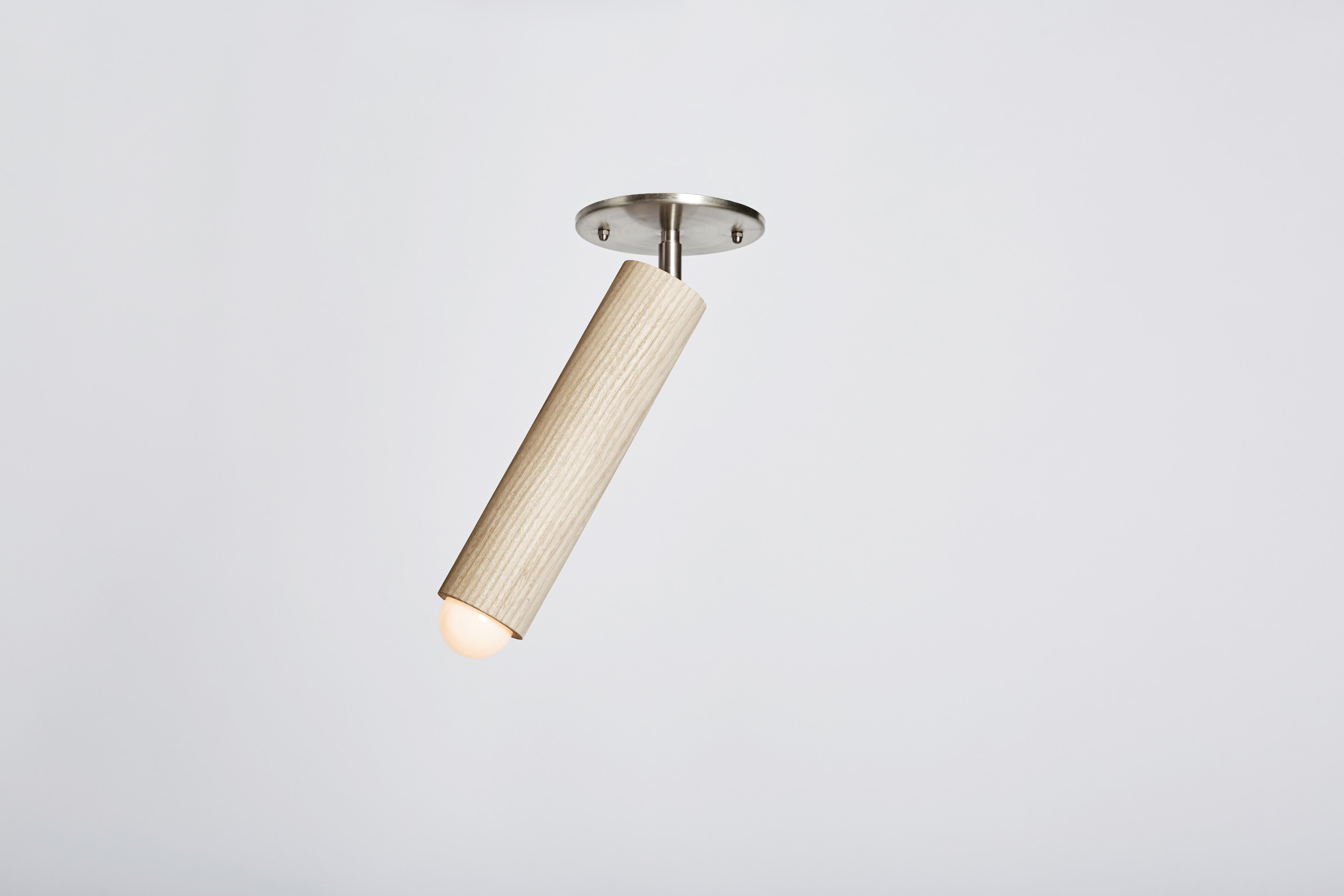 The LODGE FLUSH MOUNT is composed of a singular wooden column suspended from a metal canopy. The fixture swivels from side to side, directing light from a softly glowing bulb. Made in the USA, UL listed.

These fixtures are a custom Bleached Maple