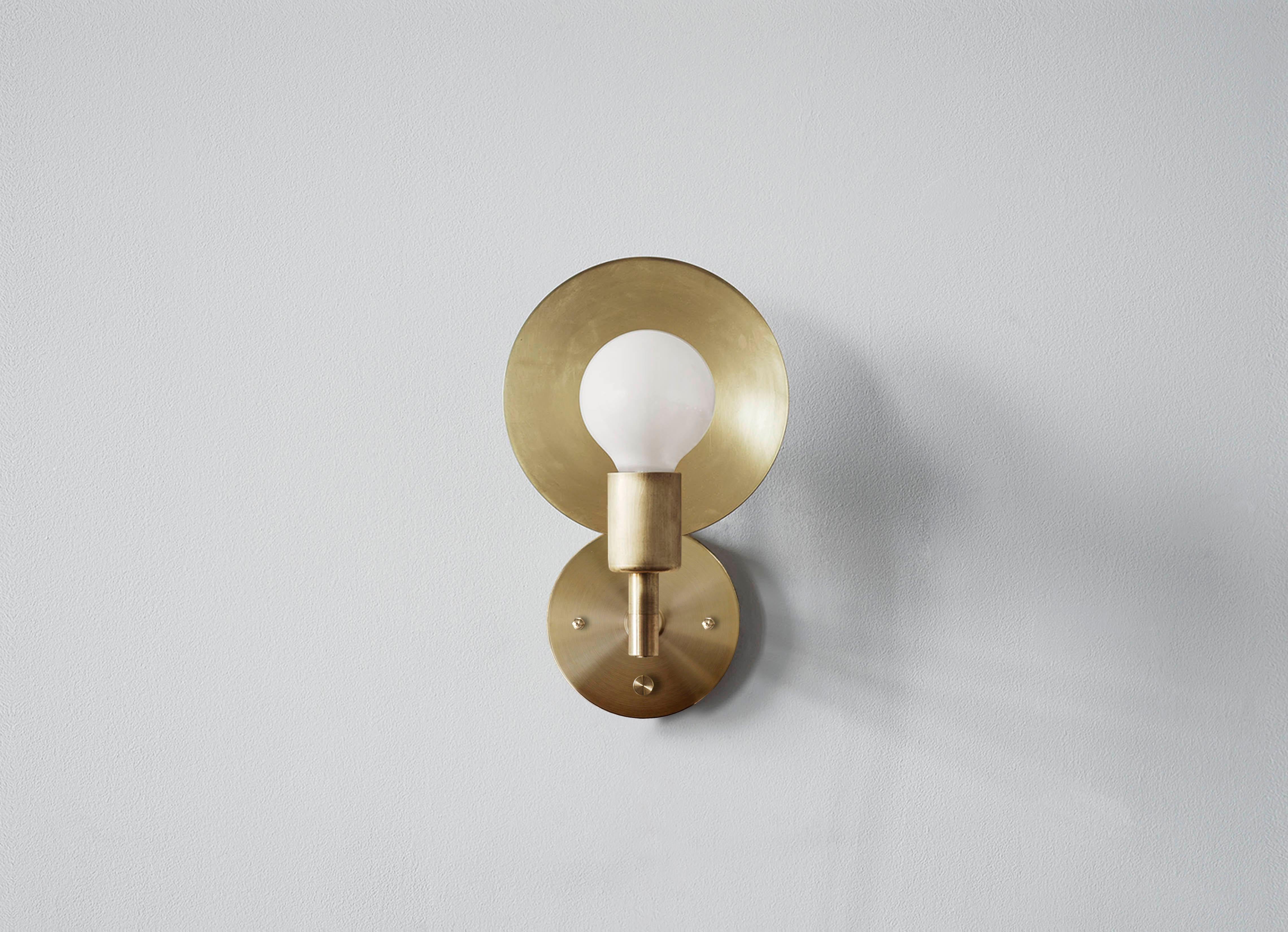The Orbit sconce is a modern interpretation of an early American candle form with a reflective spun brass disc rotating 320 degrees, the sconce can act as both a reflector and deflector of light. The most elemental piece of the Orbit series, the