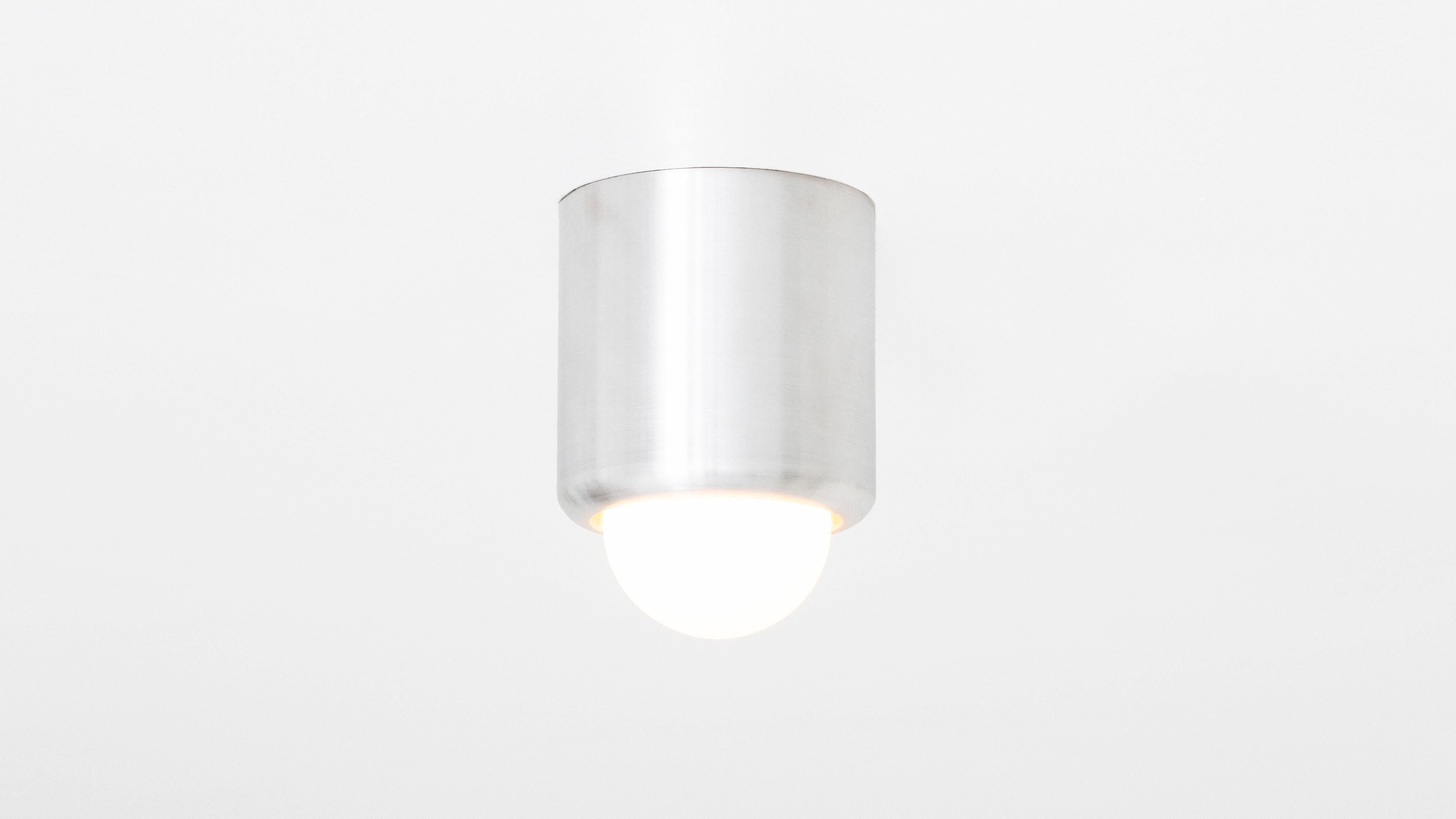 The PARK IV references porcelain fixtures of the pre-war period with its gently arched base curving lyrically into a hand blown matte porcelain bulb. The most elemental of the PARK collection, the sleek fixture works equally well on ceilings and