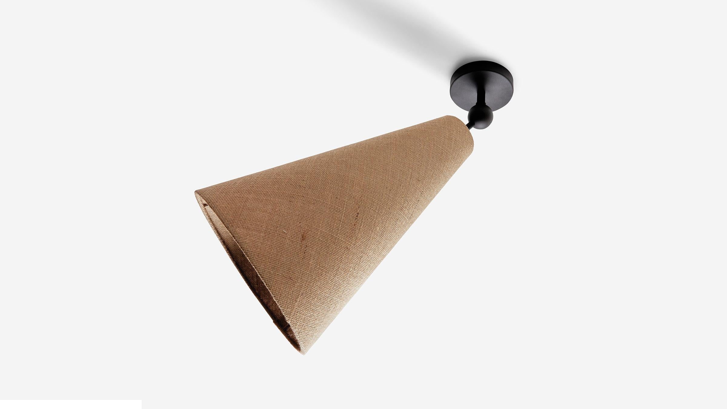 Pendolo Flush Mount is a versatile flush-mount fixture, capable of serving as a down-light or directional wall washer. Available in either Natural Burlap or Natural Linen, the cone form is expressed as a singular gesture against a ceiling. UL
