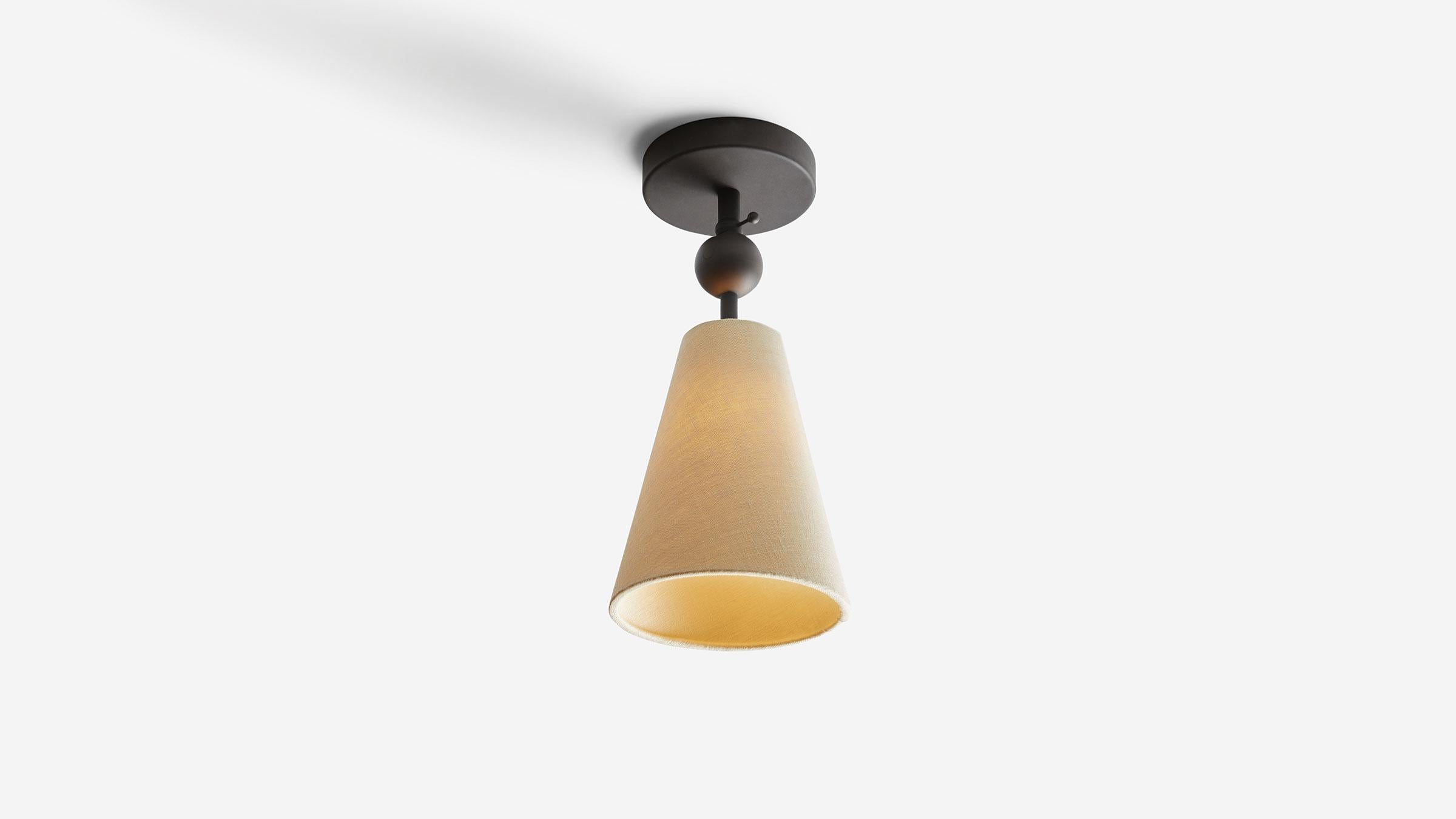 Pendolo Flush Mount is a versatile flush-mount fixture, capable of serving as a down-light or directional wall washer. Available in either Natural Burlap or Natural Linen, the cone form is expressed as a singular gesture against a ceiling. UL